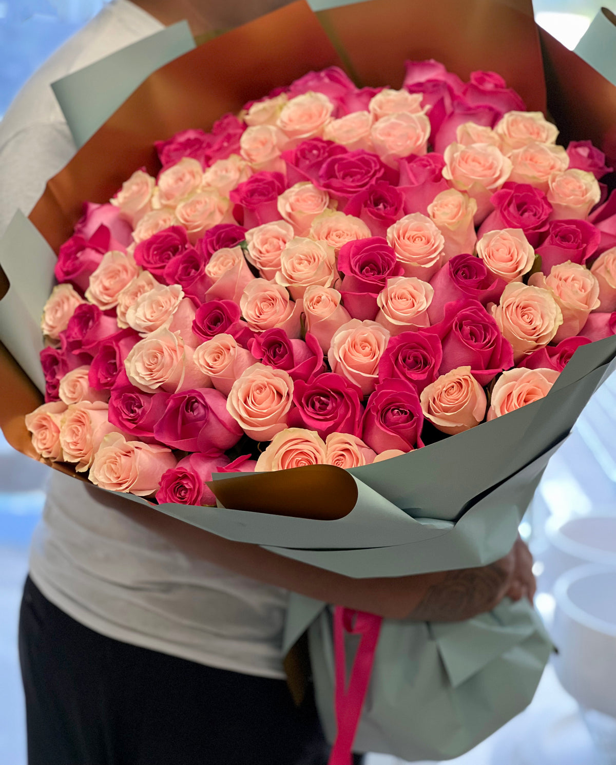 100 light pink and hot pink roses in handcrafted luxury bouquet