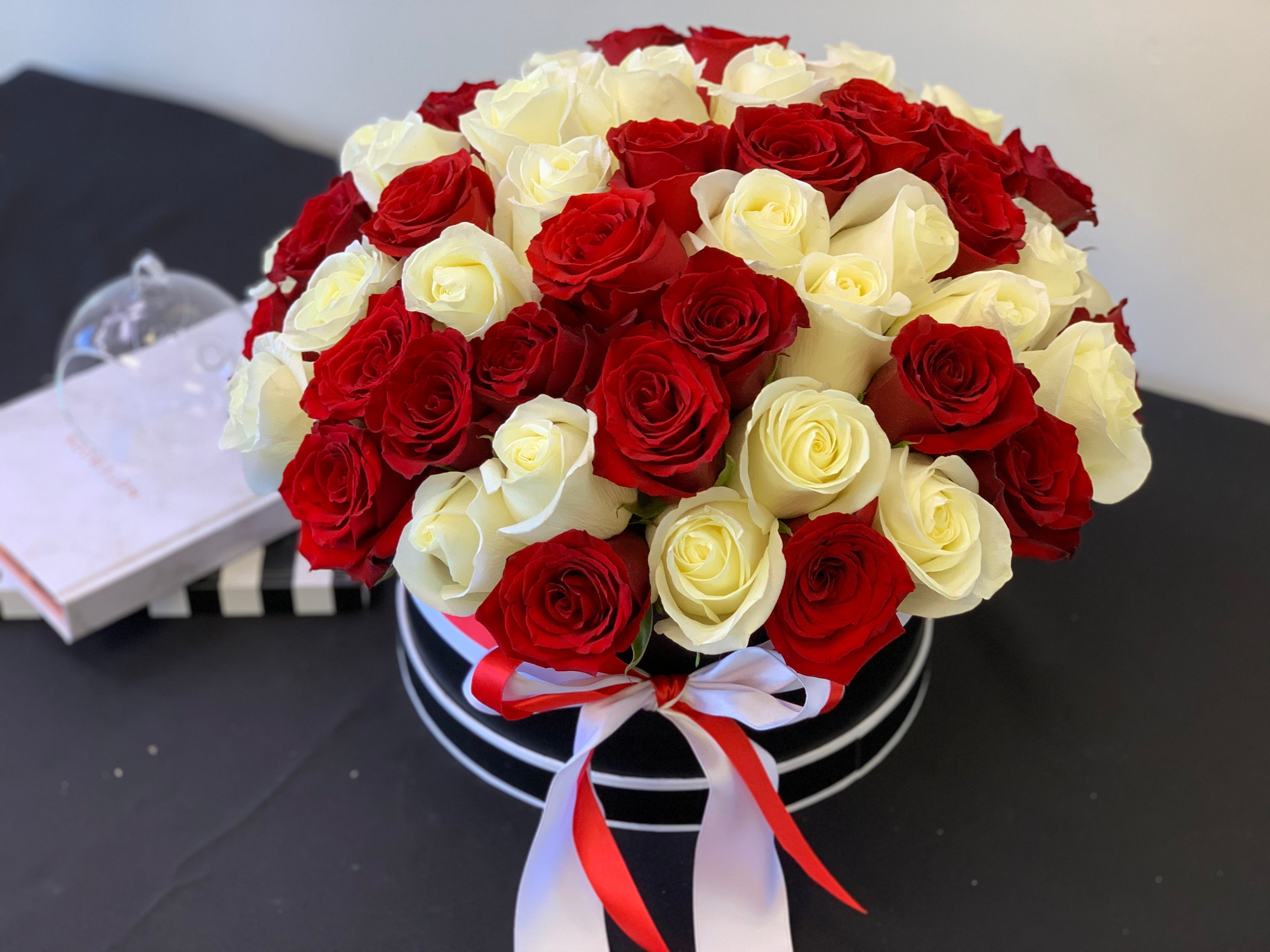 100 red and white roses arranged in a luxury flower box in Miami