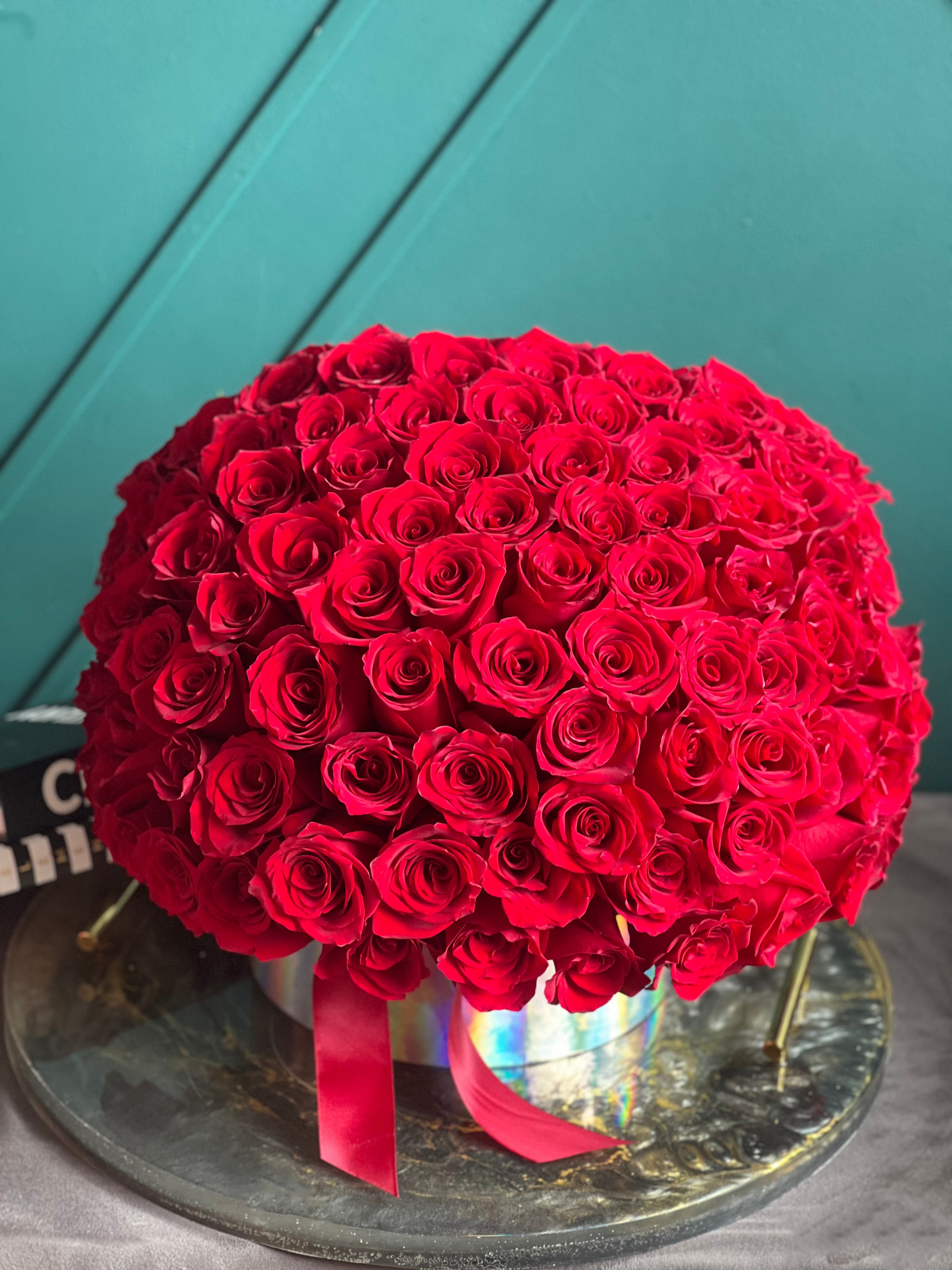 100 red roses arranged in an elegant flower box