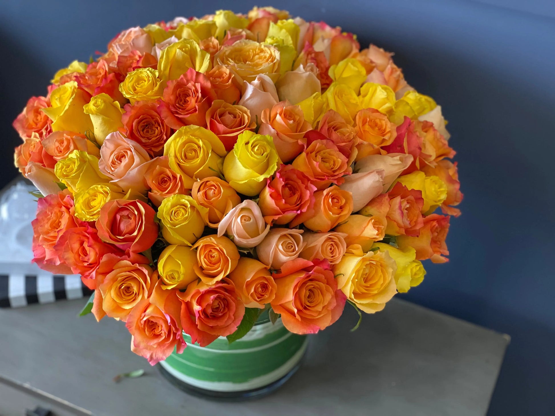 100 roses Miami arrangement in yellow orange and peach tones