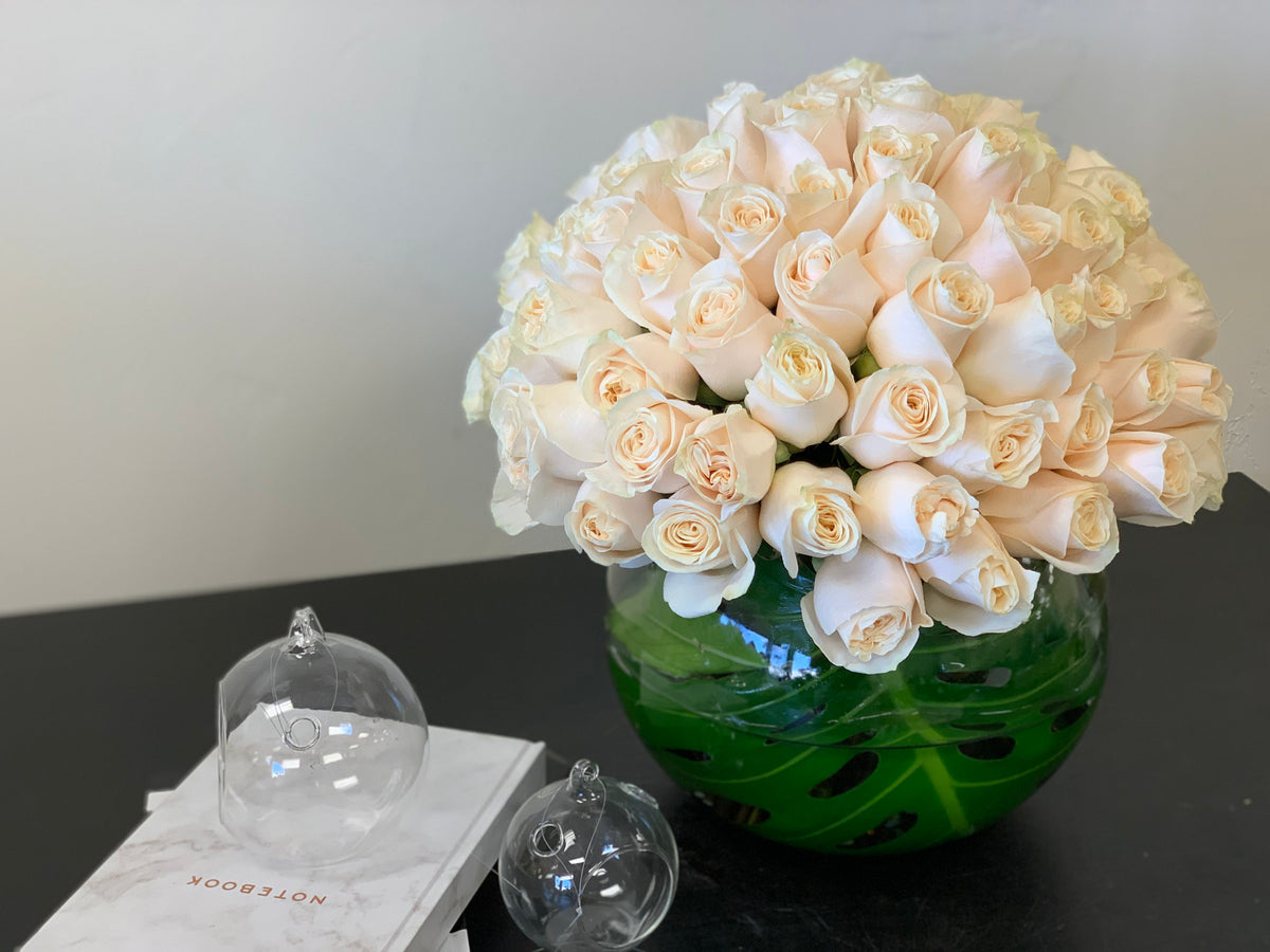 100 white roses in glass fishbowl vase Miami Beach