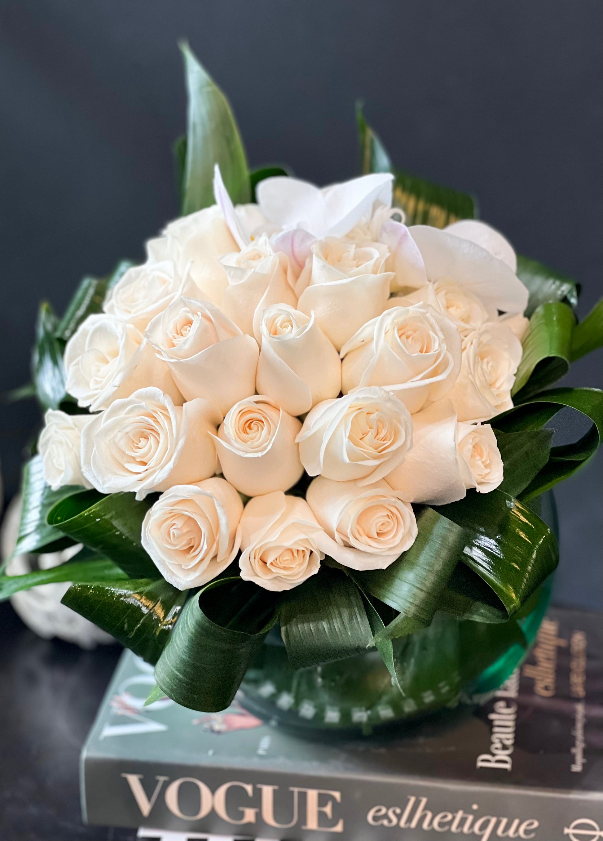 2 dozen white roses arranged in a fishbowl vase in Miami