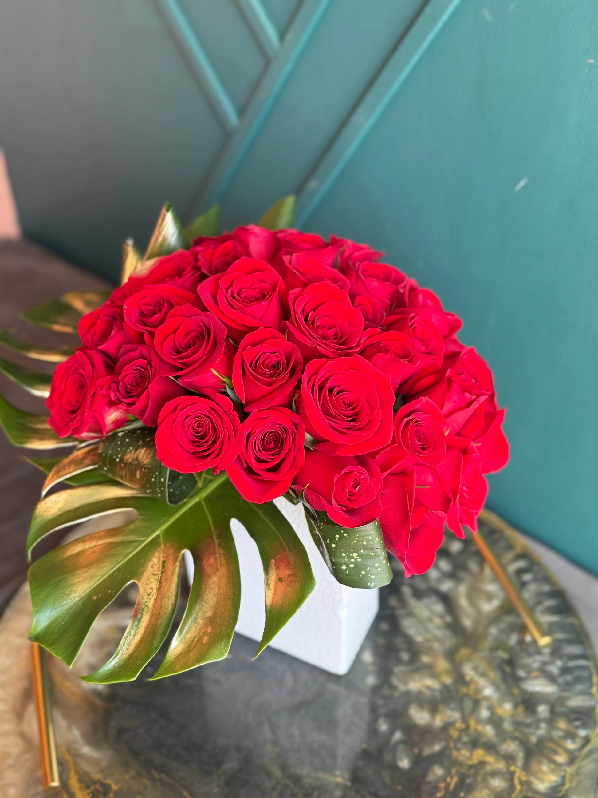 36 fresh red roses arranged in an elegant vase