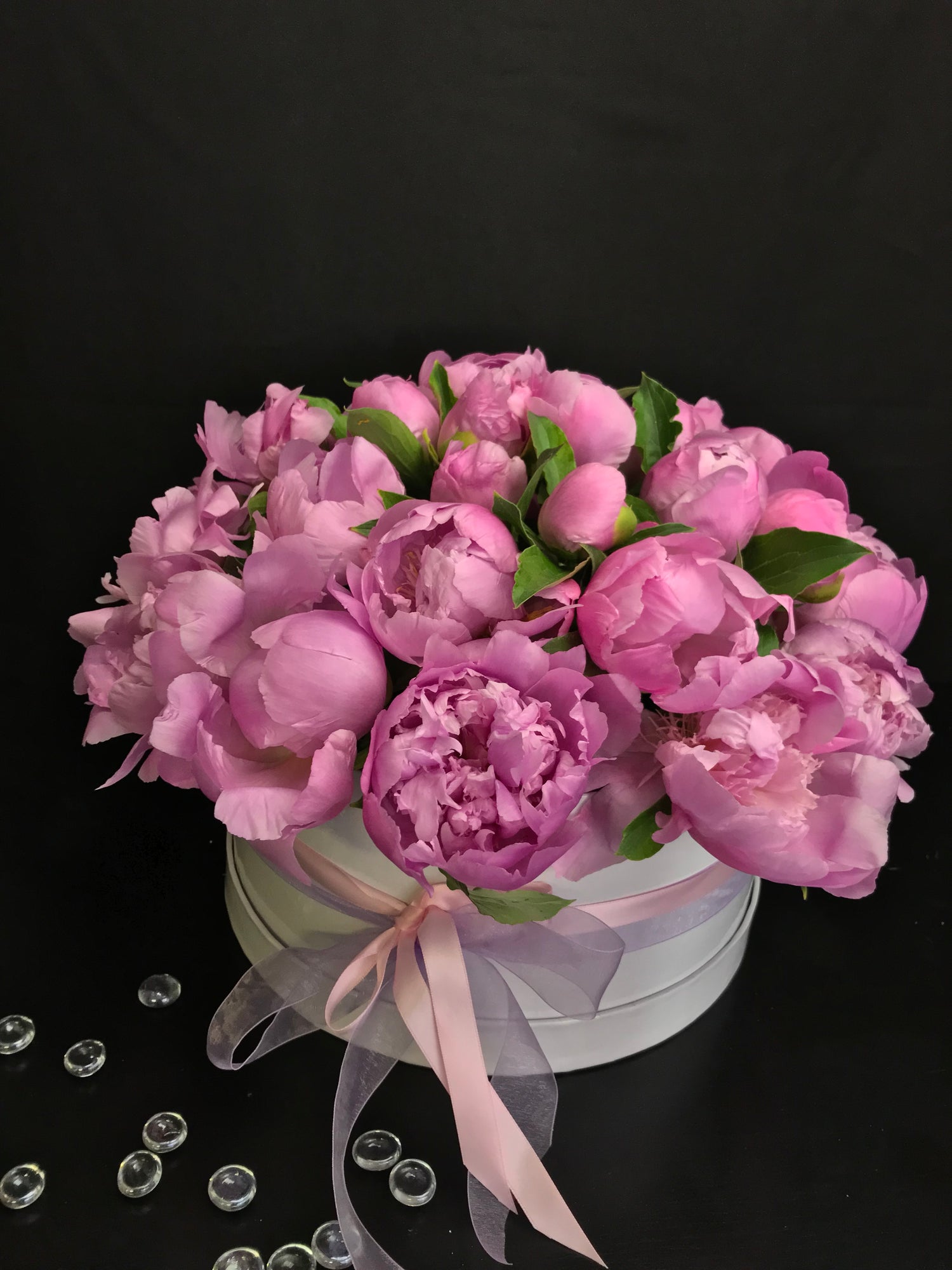 36 pink peonies arranged in an elegant white box