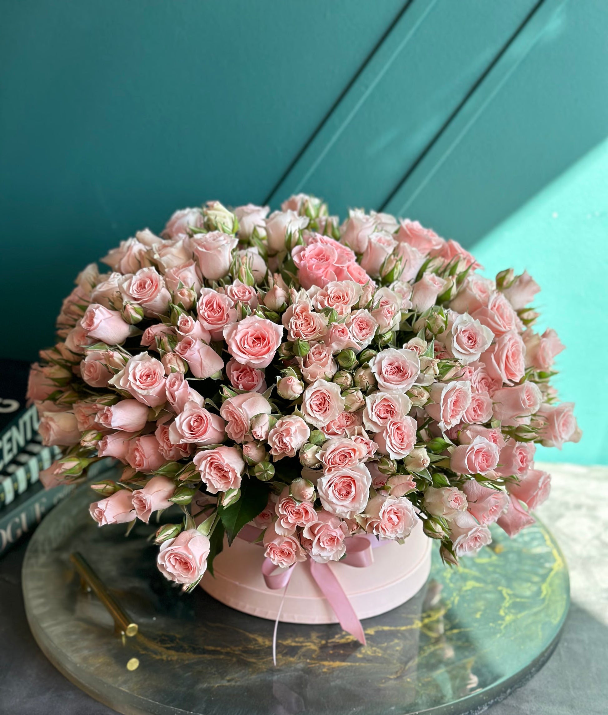 50 mini spray roses arranged in a soft pink luxury flower box