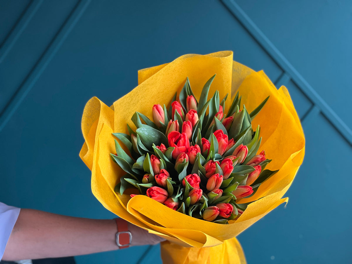 50 orange tulips with elegant wrapping by Luxury Flowers Miami