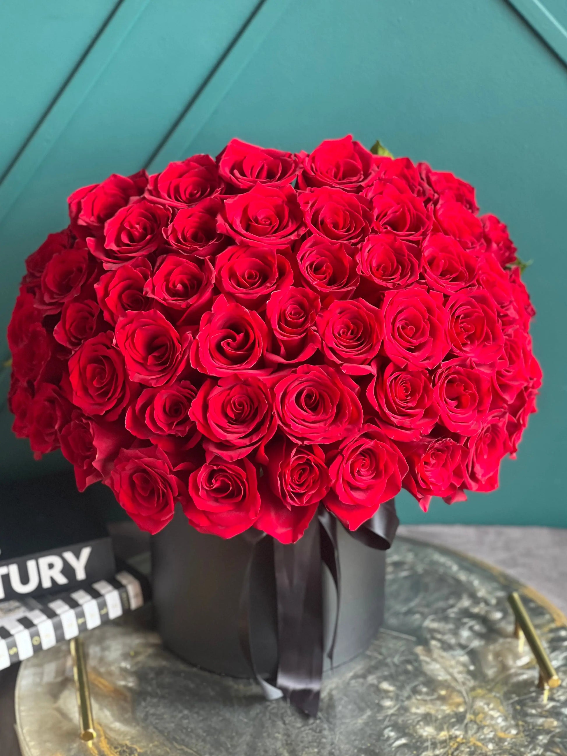 50 premium red roses in a luxury black hat box by Luxury Flowers Miami