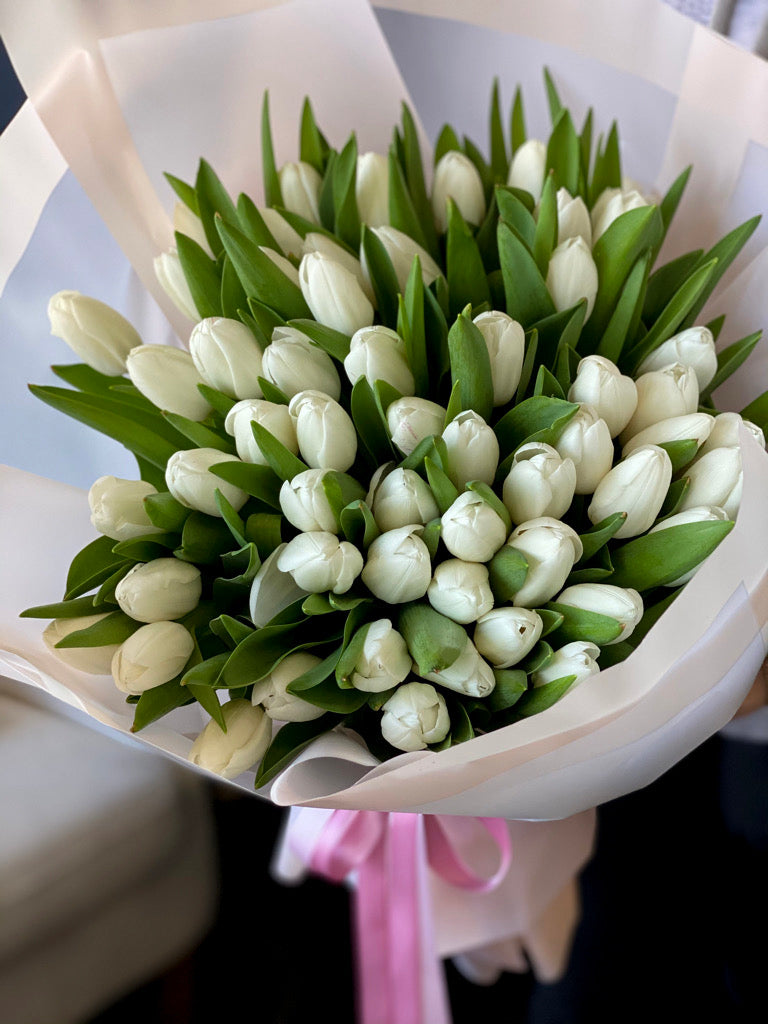 50 white tulips with elegant decorative wrapping
