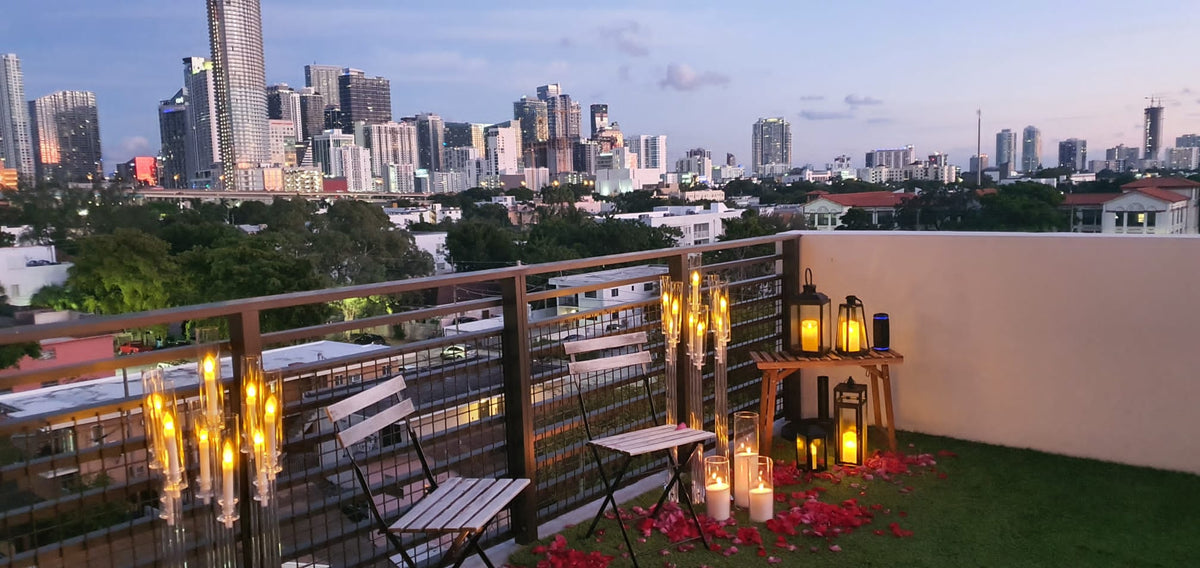 Romantic rooftop proposal setup in Miami with MARRY ME letters and roses