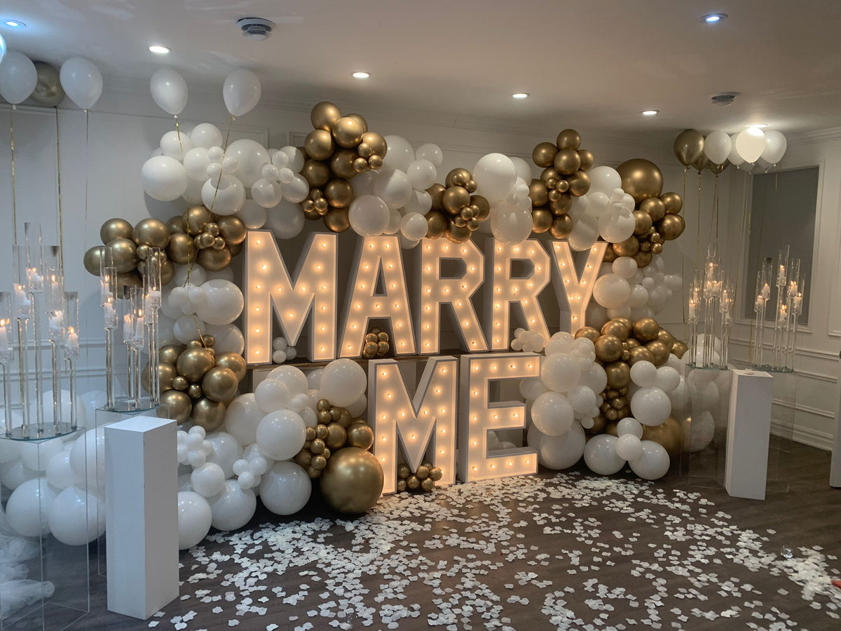 Marry Me proposal in Miami with 3-ft MARRY ME letters, roses and romantic decor
