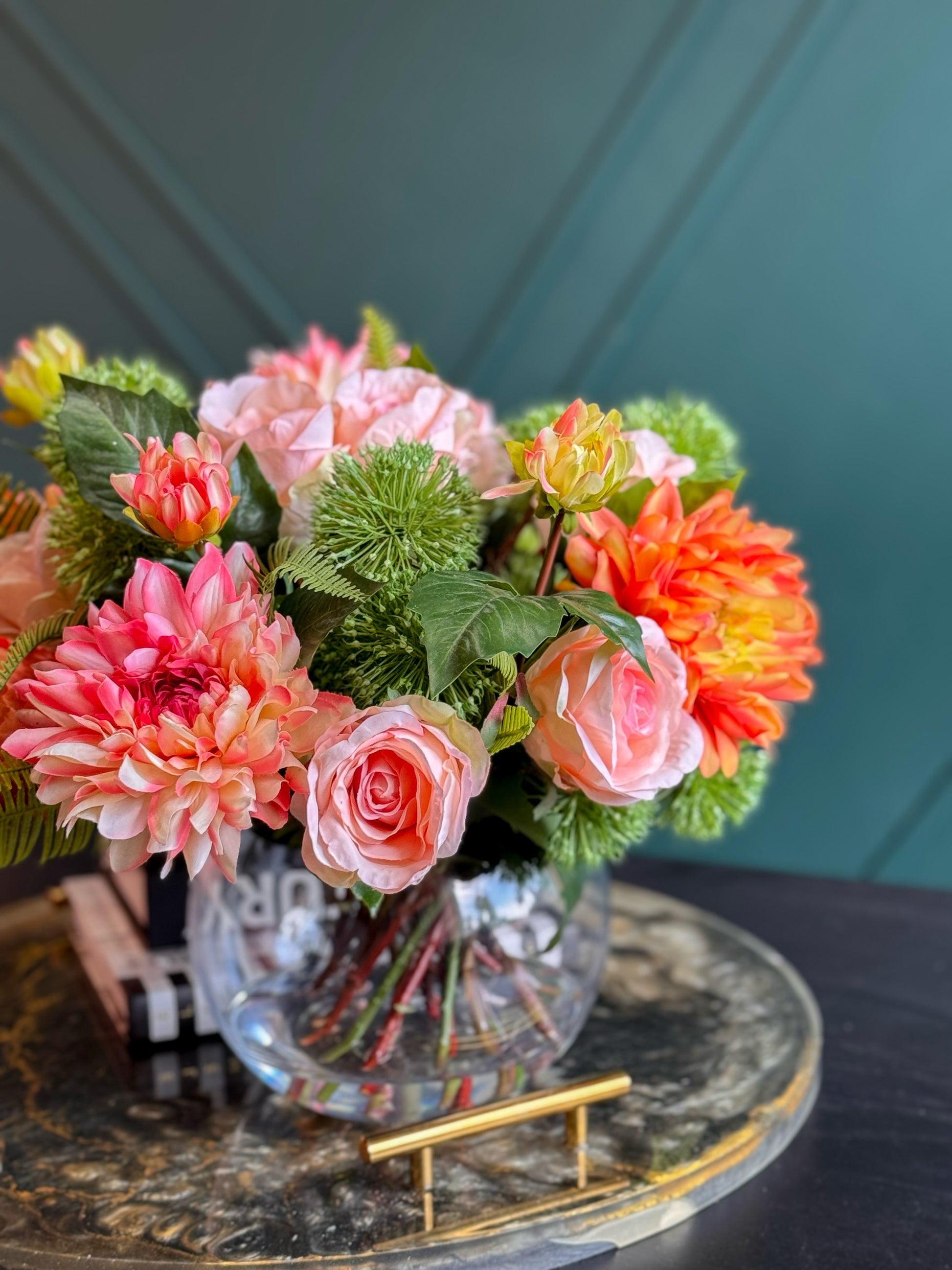 Artificial pink peonies and coral dahlias arranged in a luxury glass centerpiece.