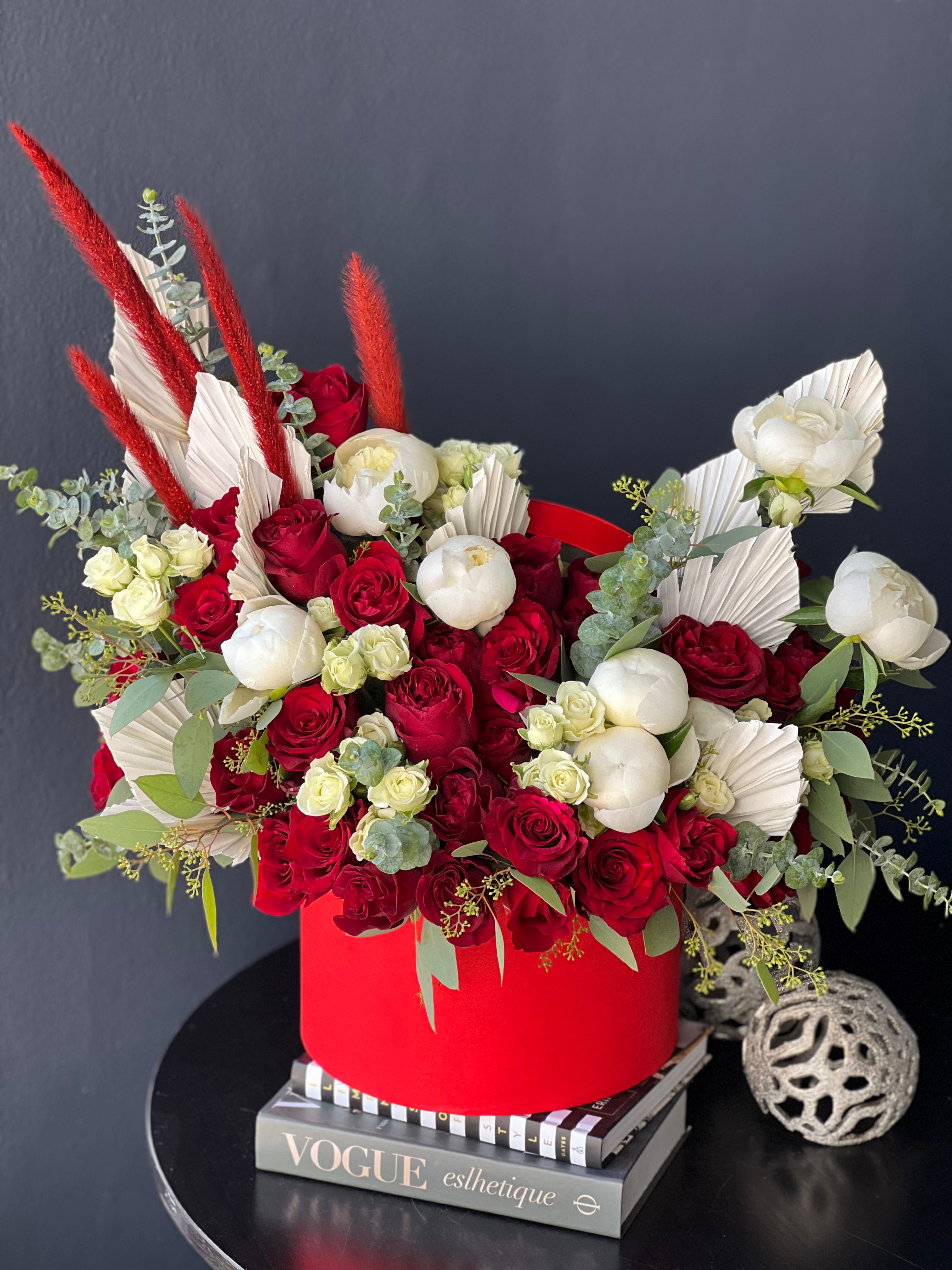 Artistic red roses and peonies arrangement in red hat box Miami