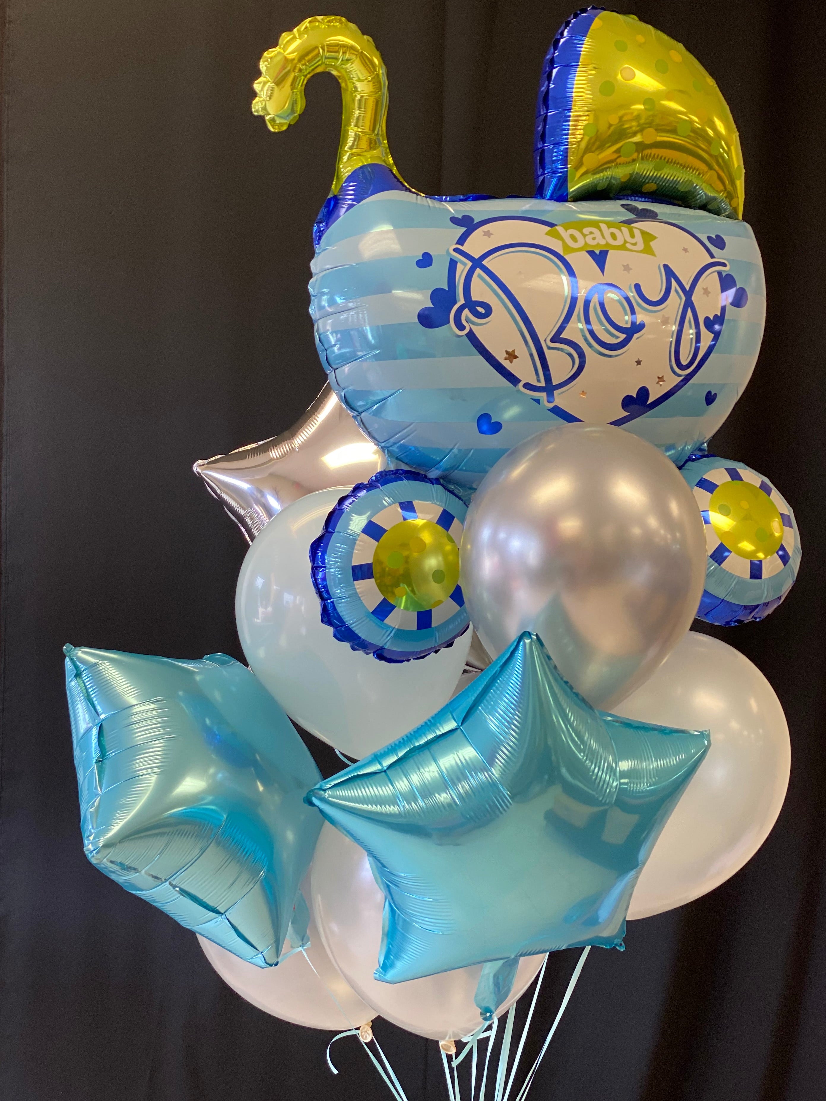 Baby shower balloon arrangement with extra large stroller balloon