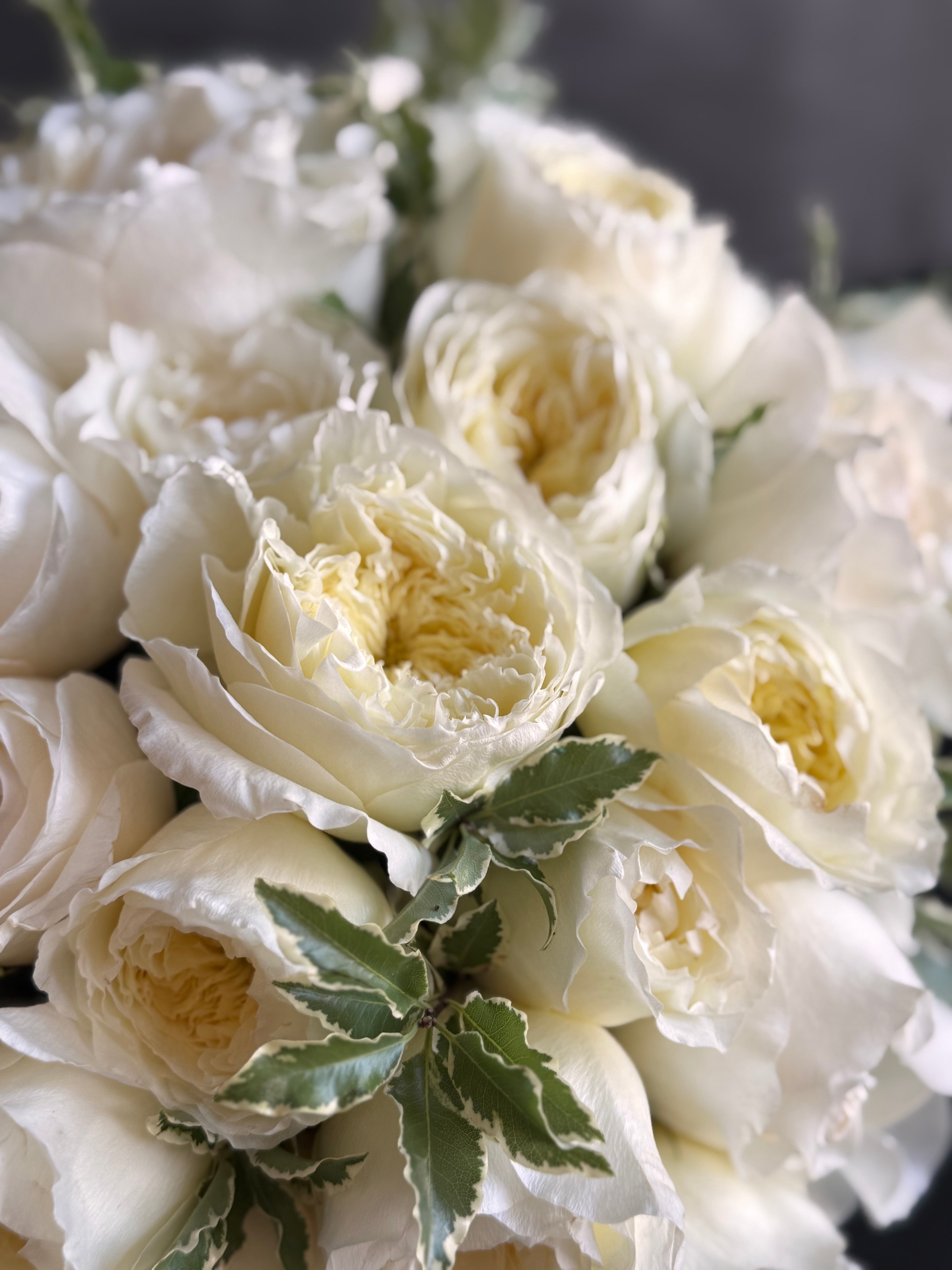 Beautiful garden roses arrangement in a low container for special occasions