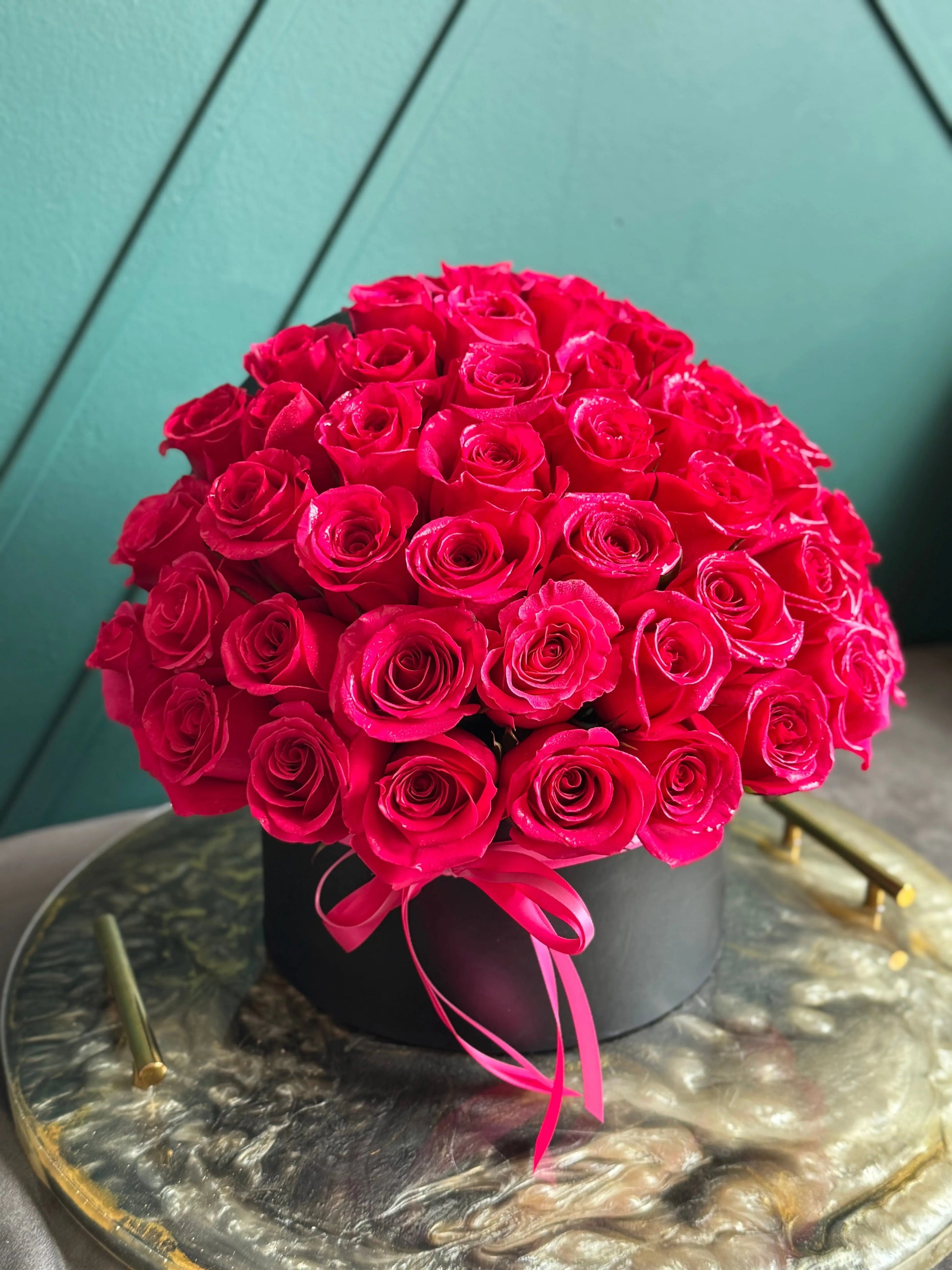 Beautiful hot pink roses in a luxury floral box for Miami delivery