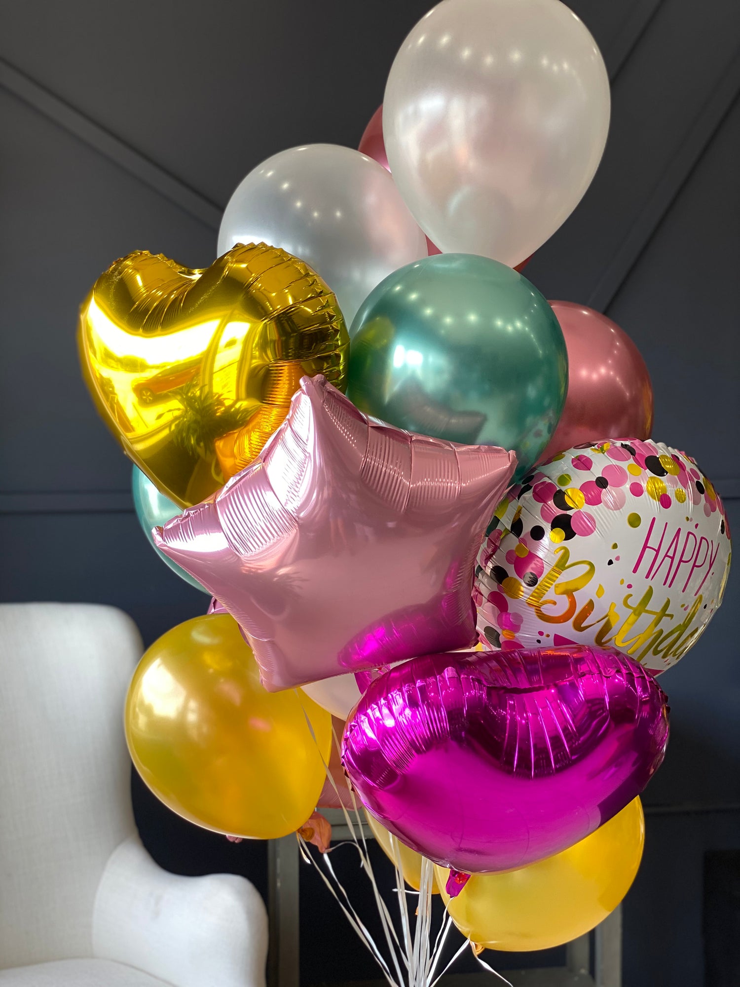 Birthday balloon arrangement with 24 balloons in bright colors