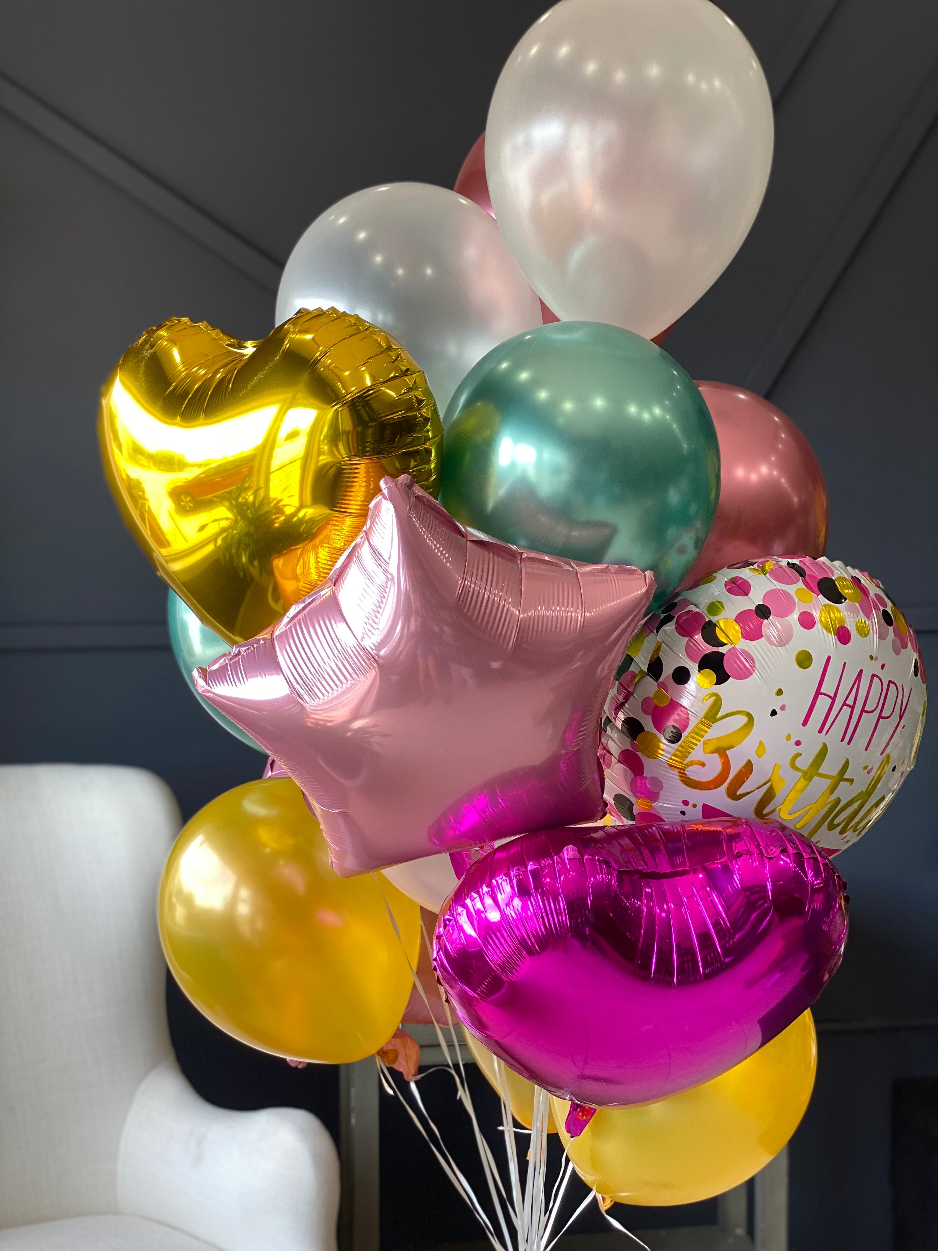 Birthday balloon arrangement with 24 balloons in bright colors