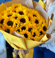Bright bouquet of 50 fresh sunflowers beautifully wrapped by Luxury Flowers Miami