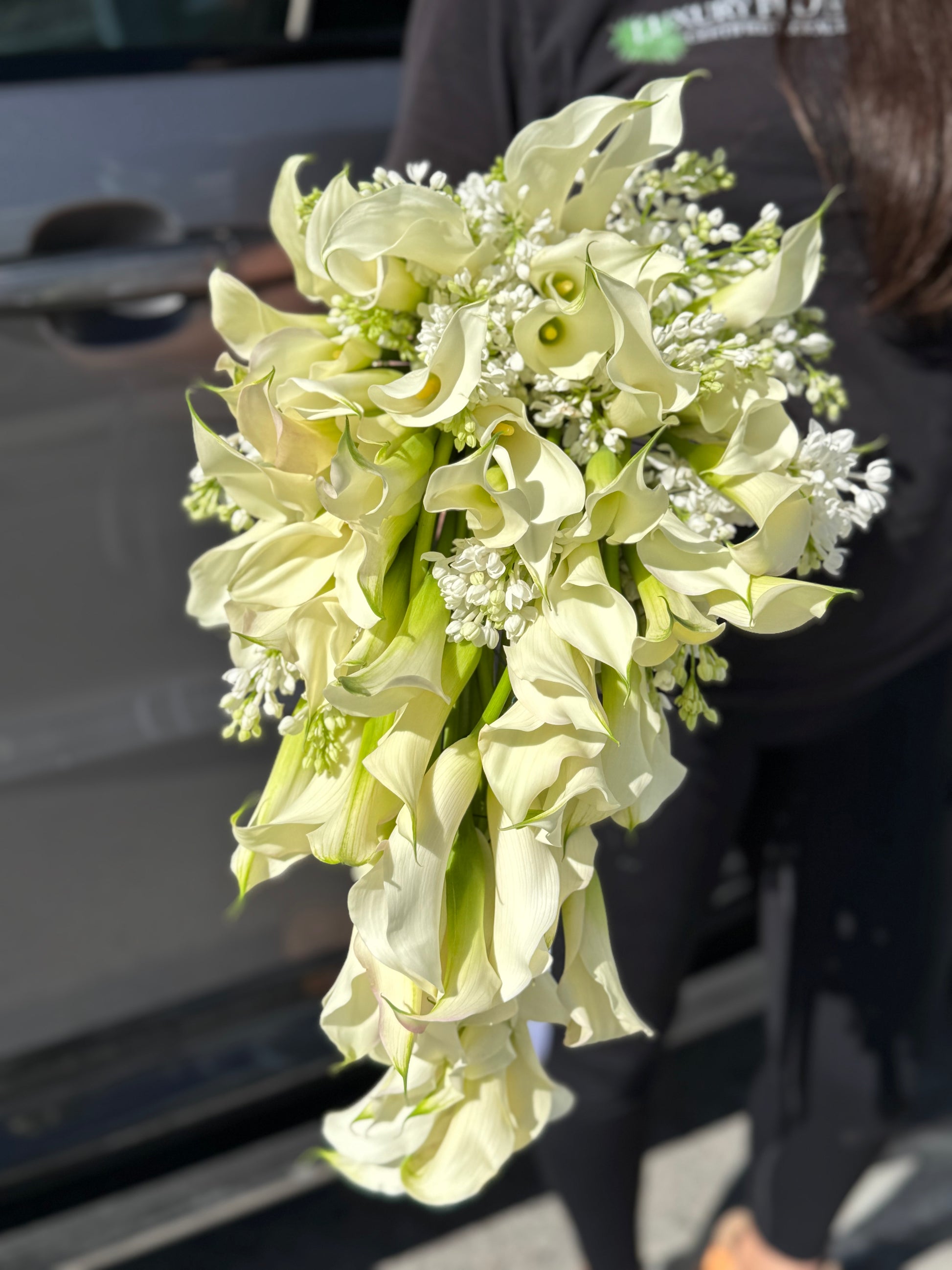Cascading bridal bouquet with mini calla lilies and lilac