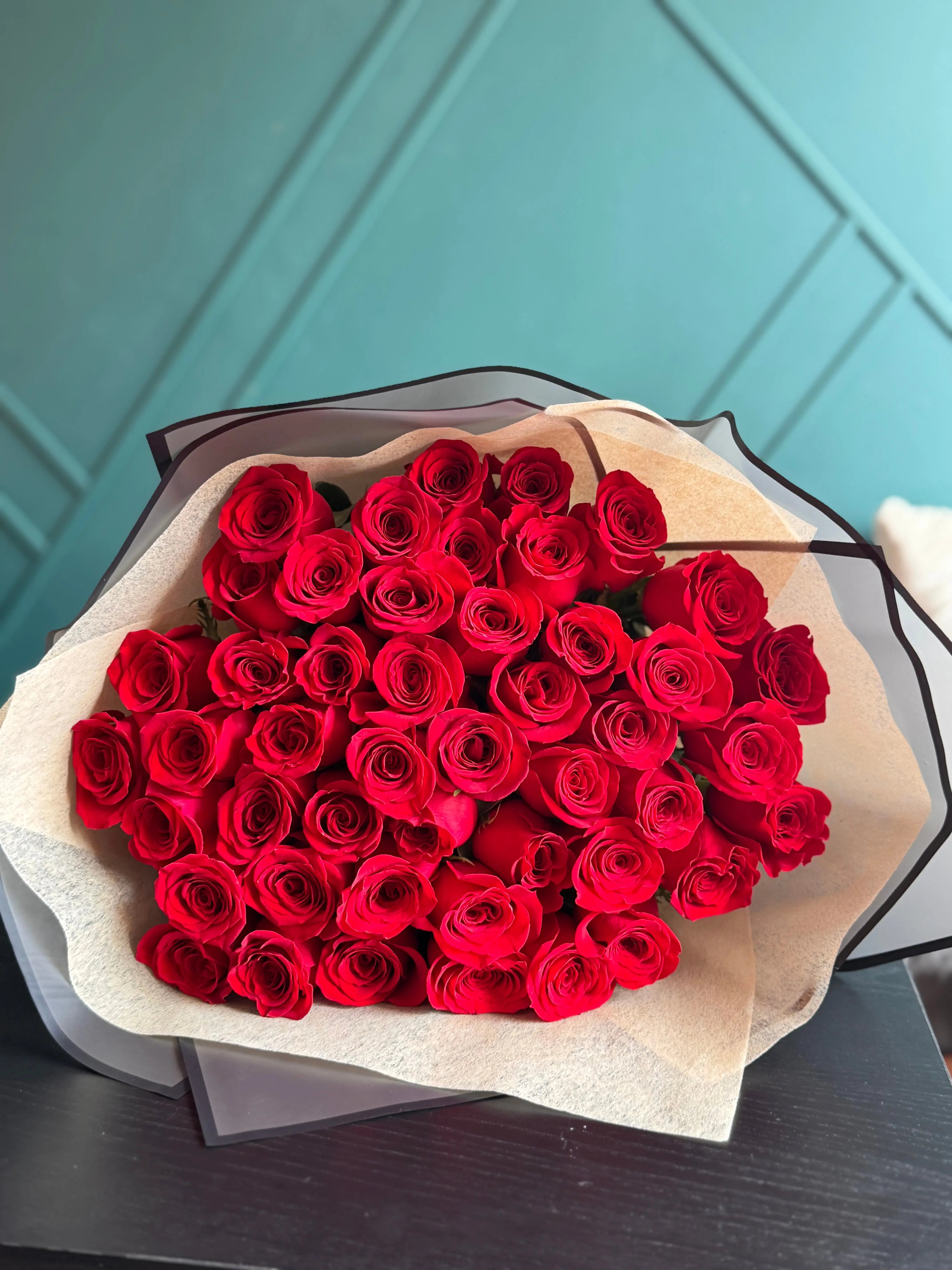 Classic bouquet of 50 red roses wrapped in premium floral paper