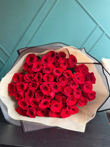 Classic bouquet of 50 red roses wrapped in premium floral paper