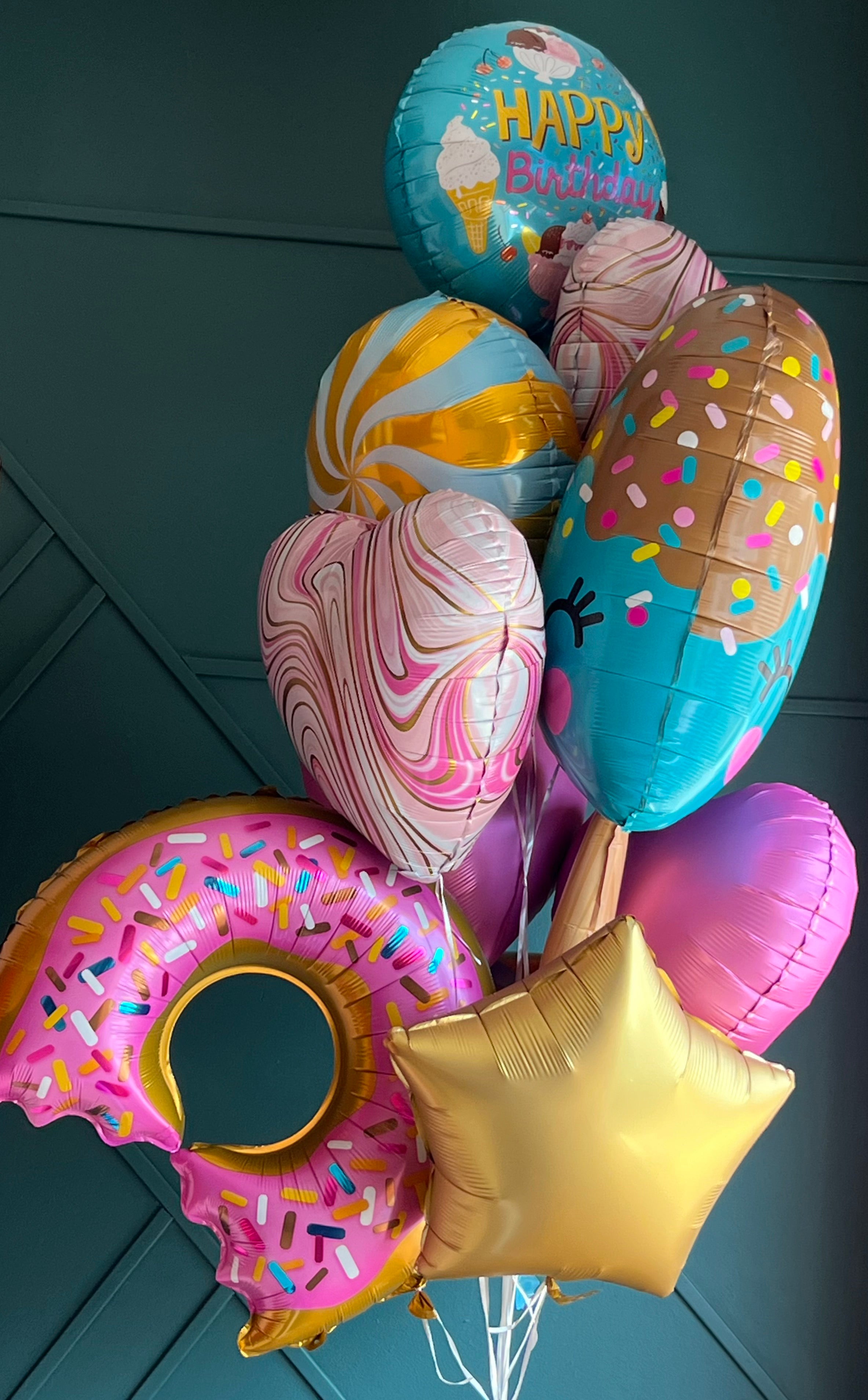 Colorful birthday balloon bouquet with candy and ice cream theme