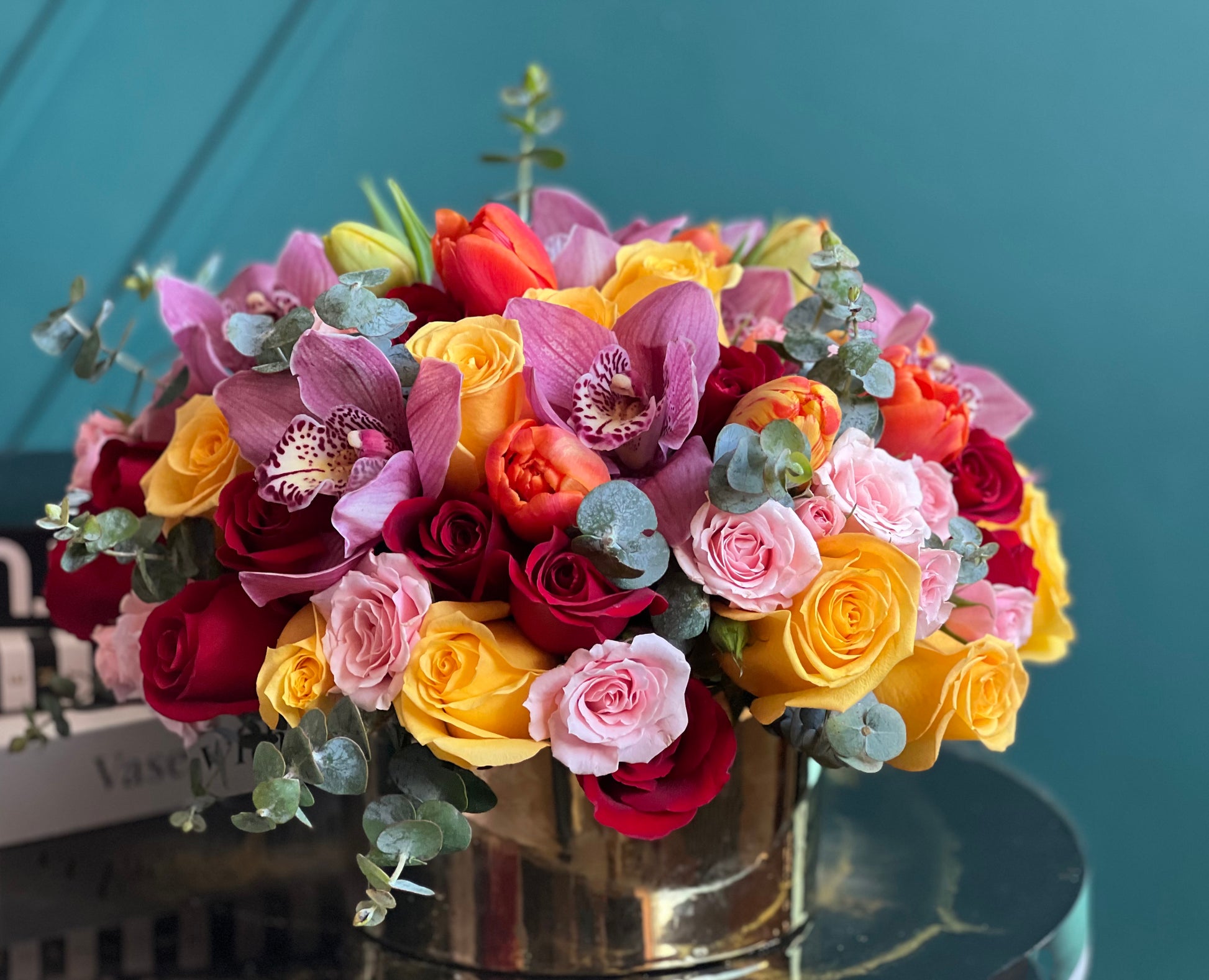 Colorful luxury floral arrangement with roses and orchids