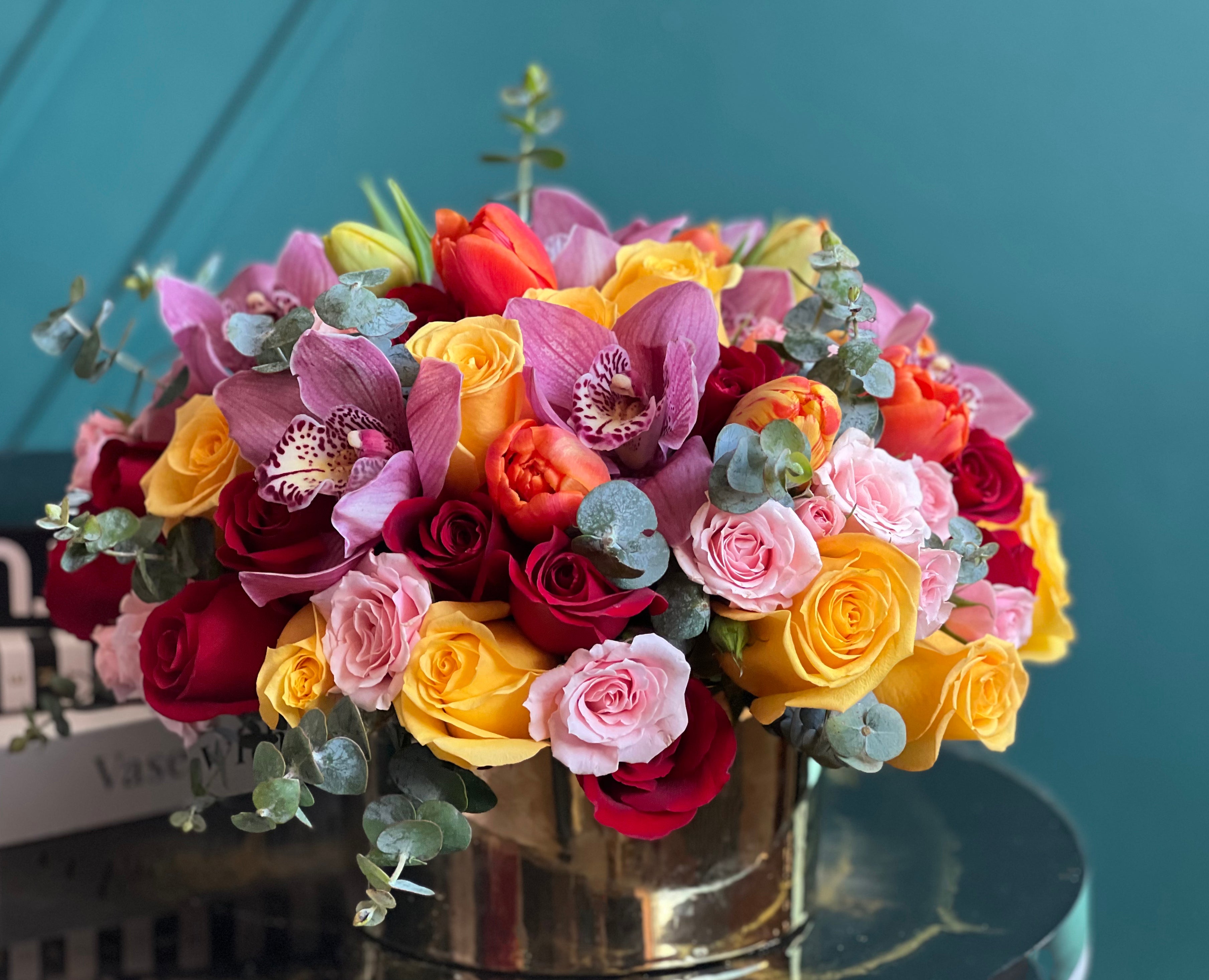 Colorful luxury floral arrangement with roses and orchids