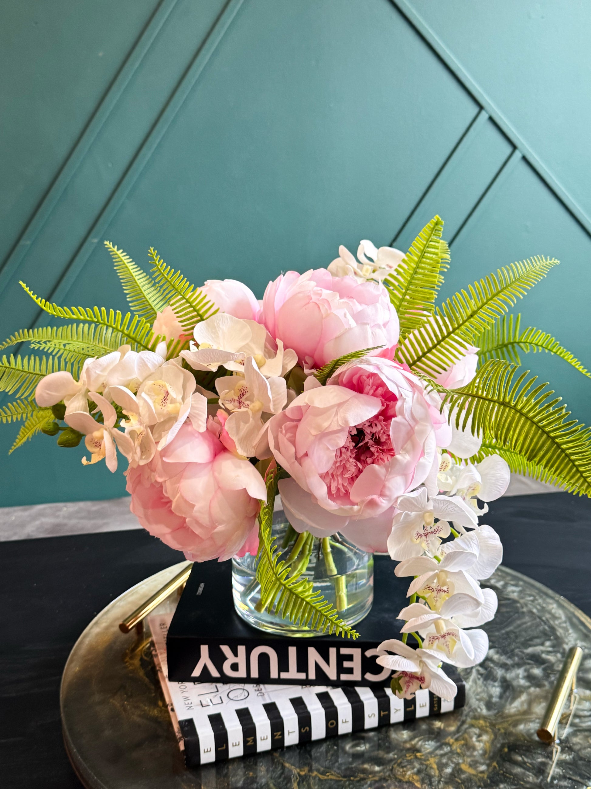 Contemporary artificial flower arrangement in a glass vase featuring Real Touch peonies, orchids, and fern foliage.