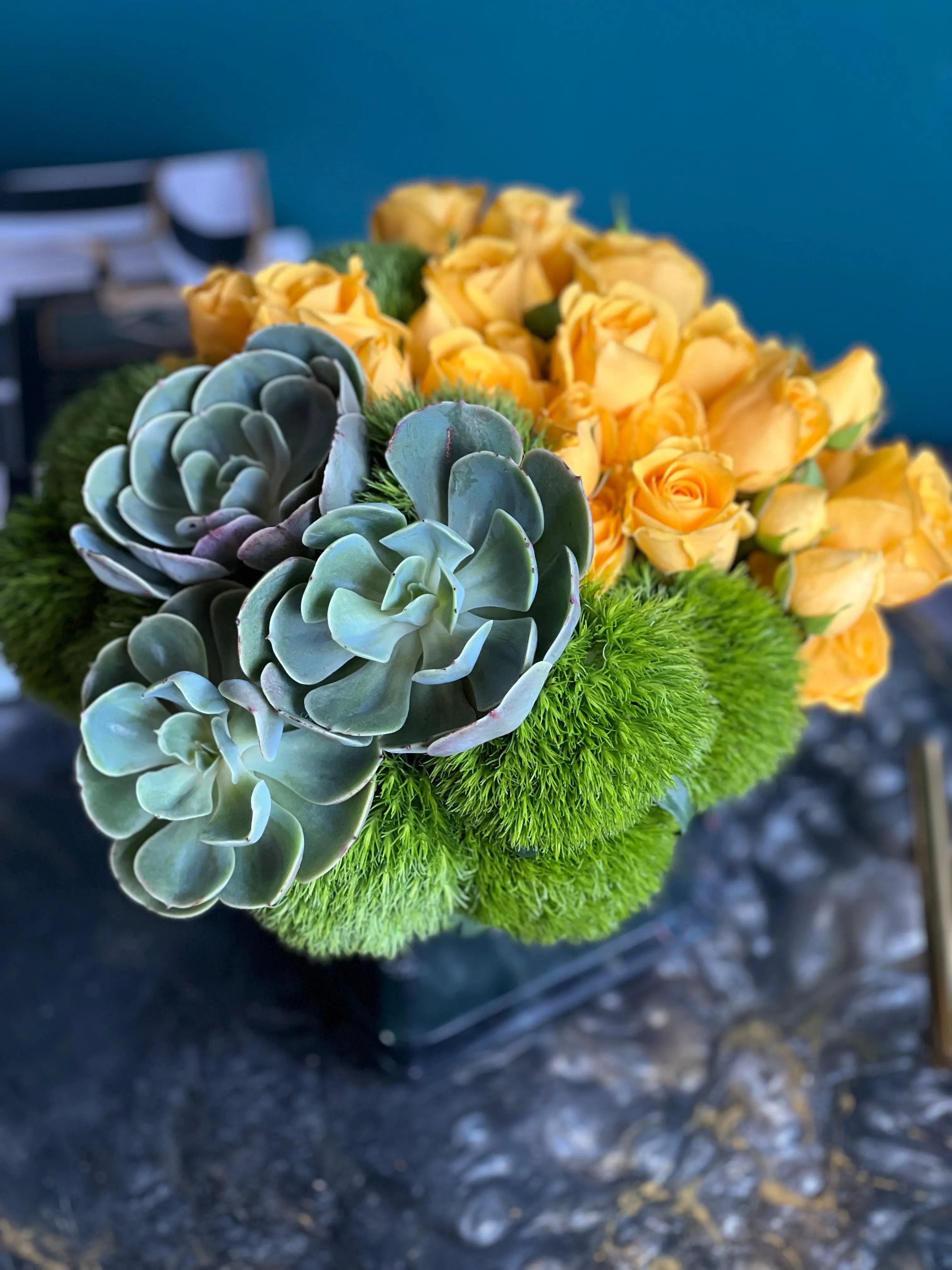 Contemporary yellow roses and succulents flower arrangement