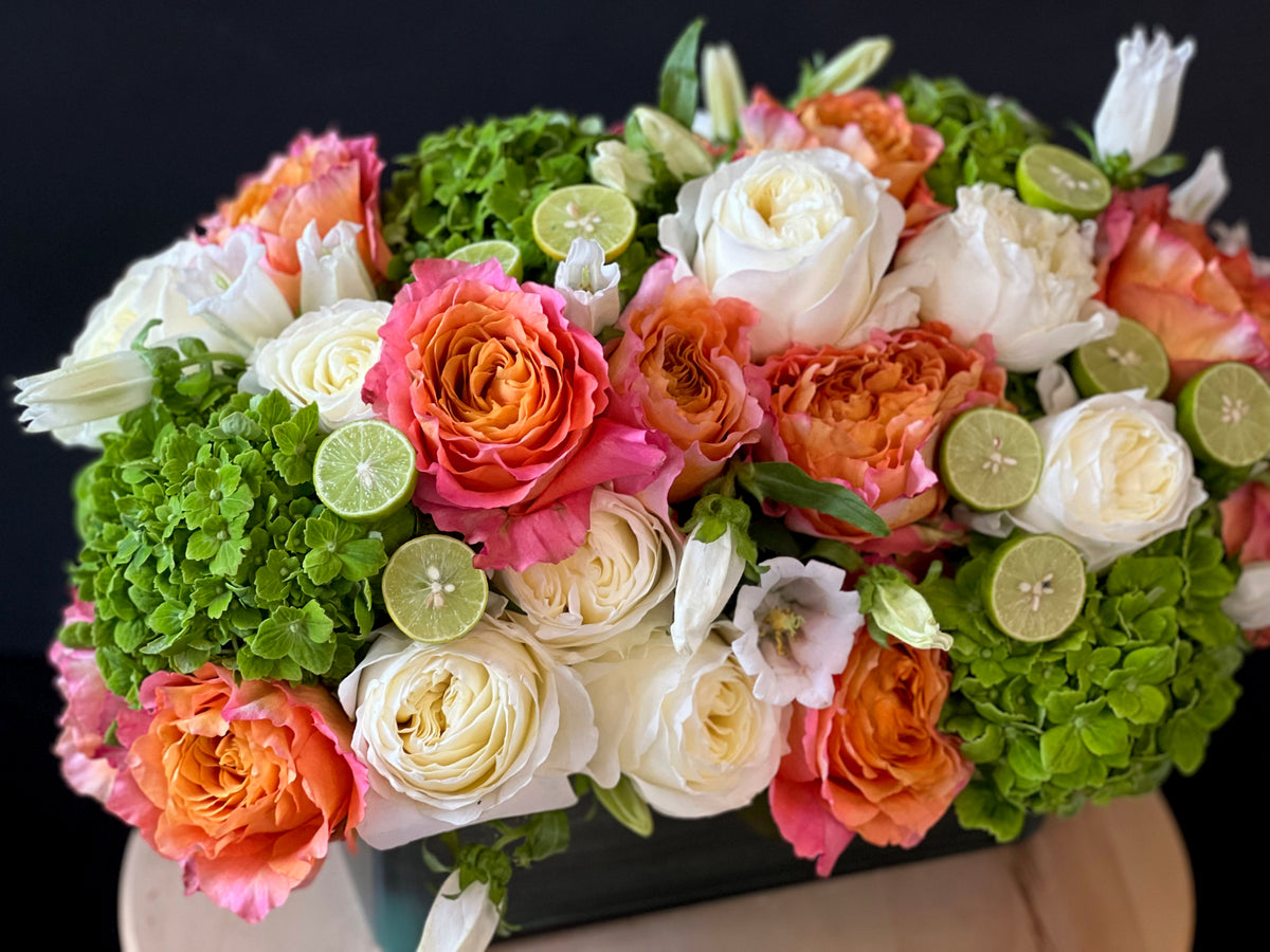 Coral garden roses and green hydrangea flower arrangement