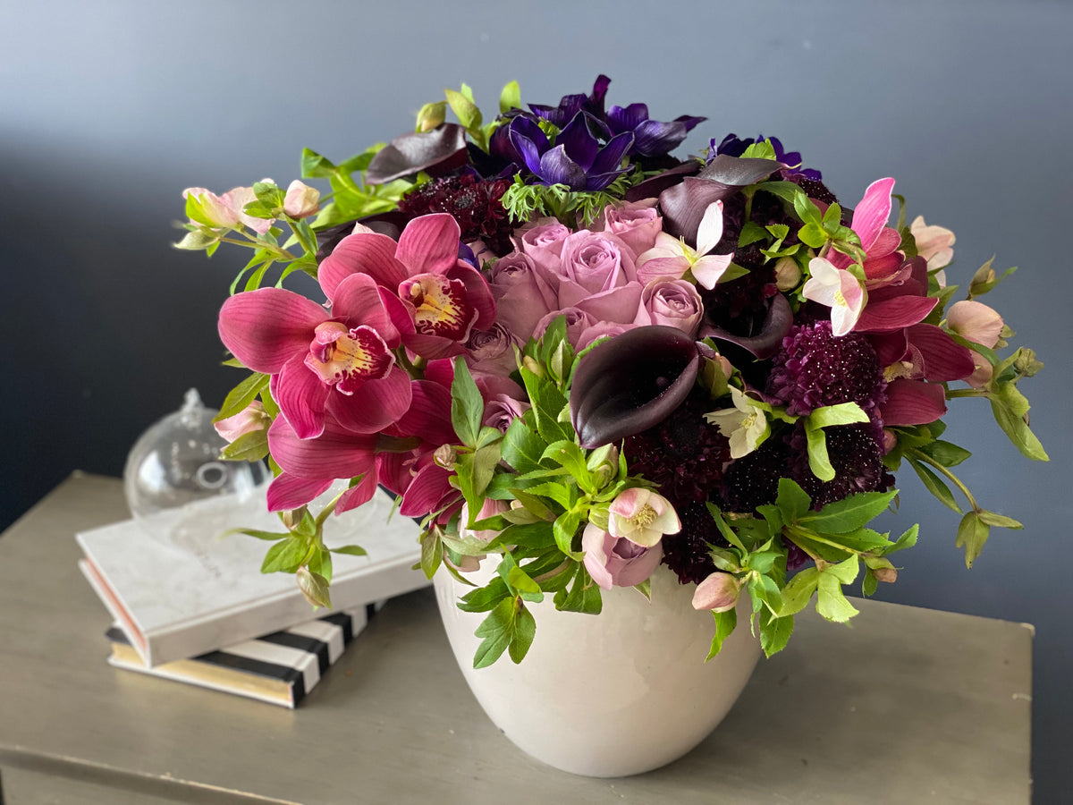 Dark purple calla lilies and orchids flower arrangement