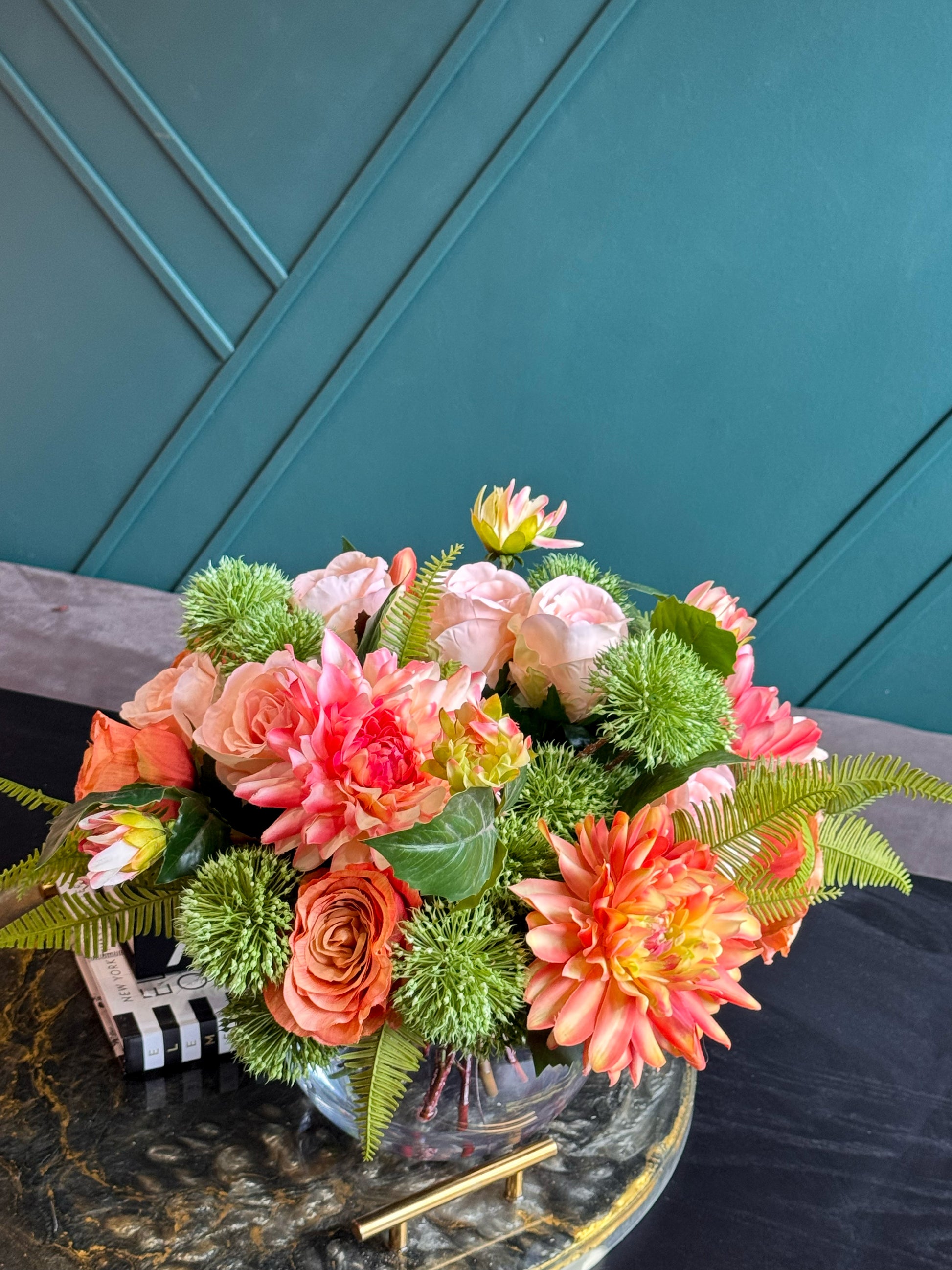 Decorative Real Touch flowers in a glass vase for elegant interior styling.