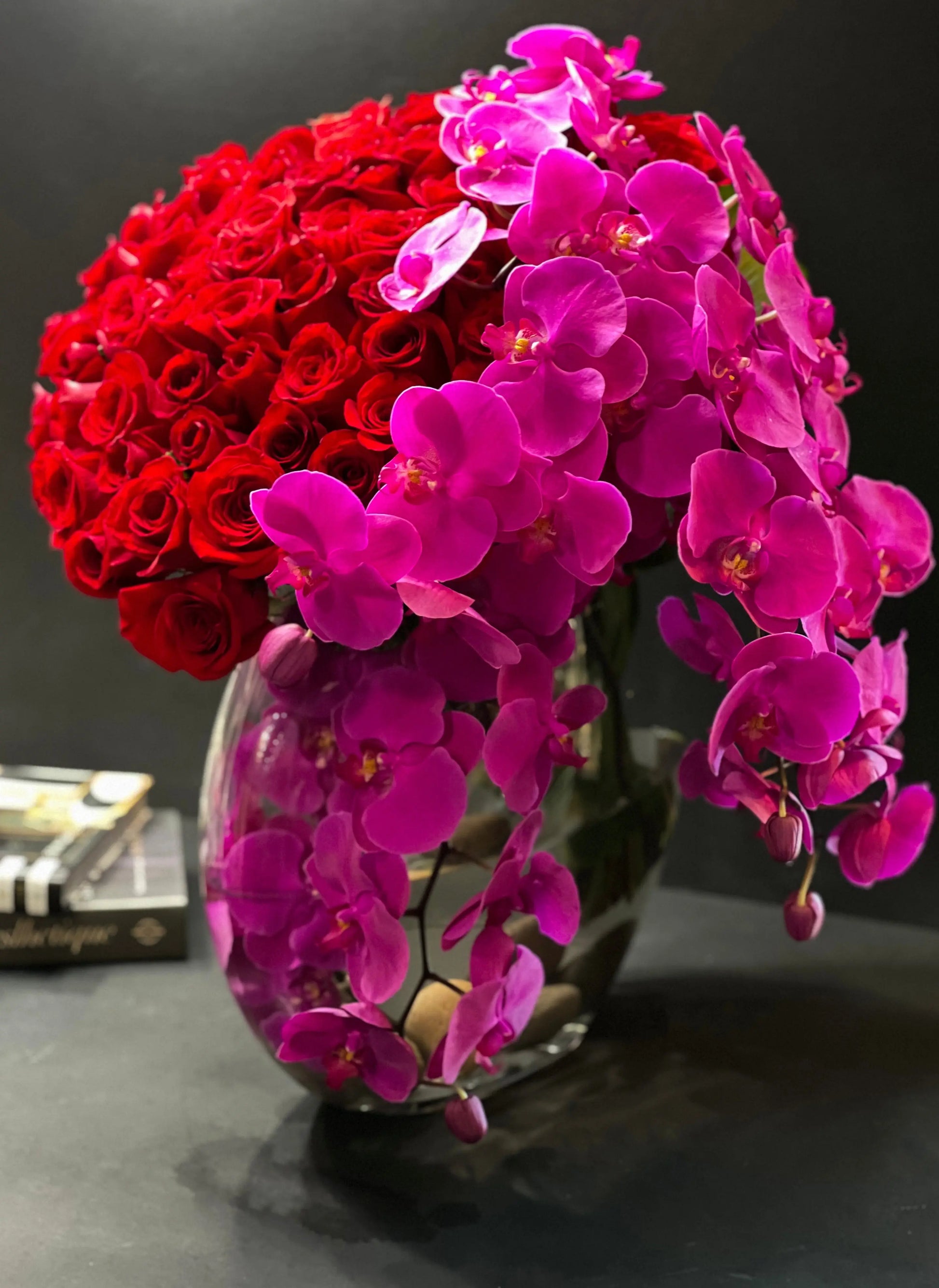 Designer red rose and Phalaenopsis orchid waterfall arrangement