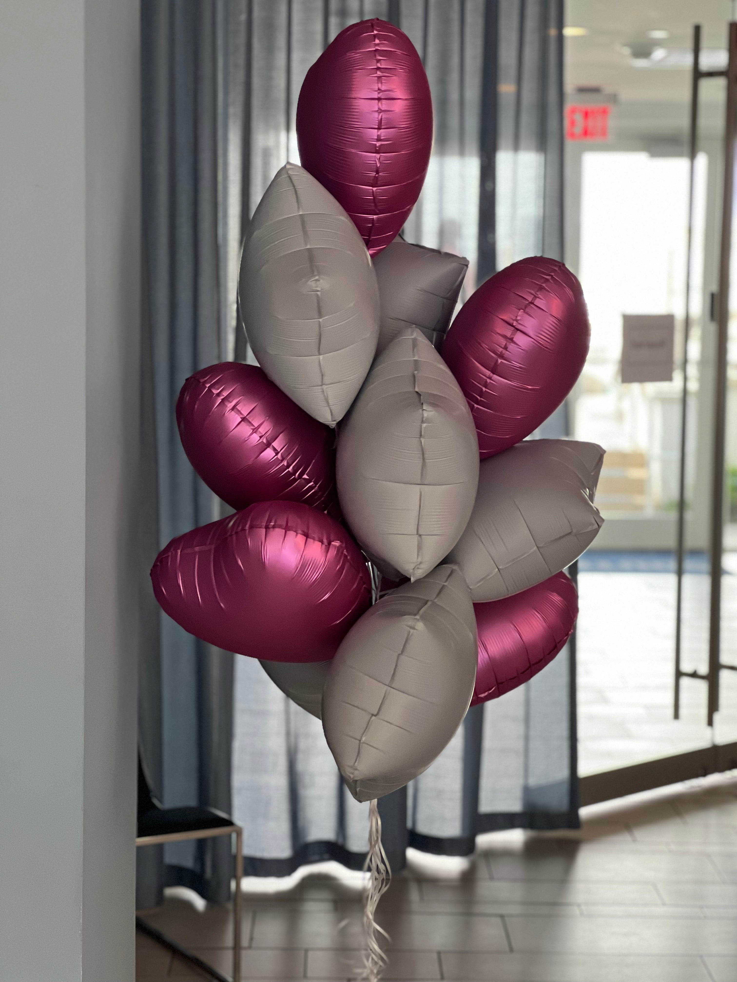 Dozen pink and white balloons arranged by Luxury Flowers Miami