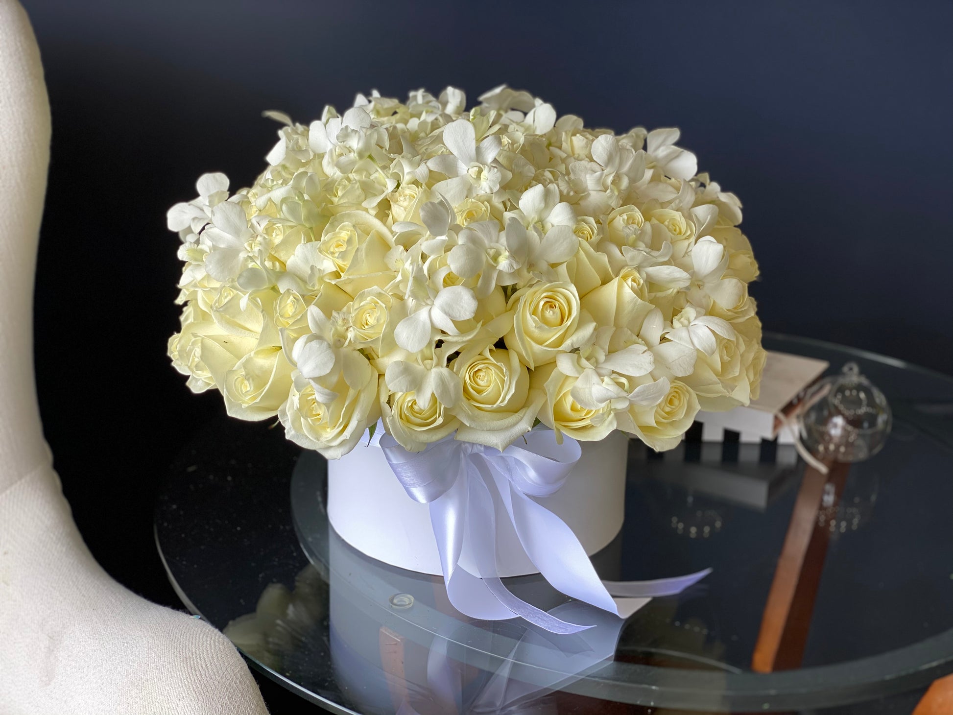 Elegant all-white roses and orchids floral arrangement