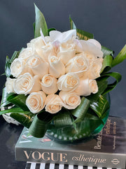 Elegant arrangement of 24 white roses in a glass fishbowl vase by Luxury Flowers Miami