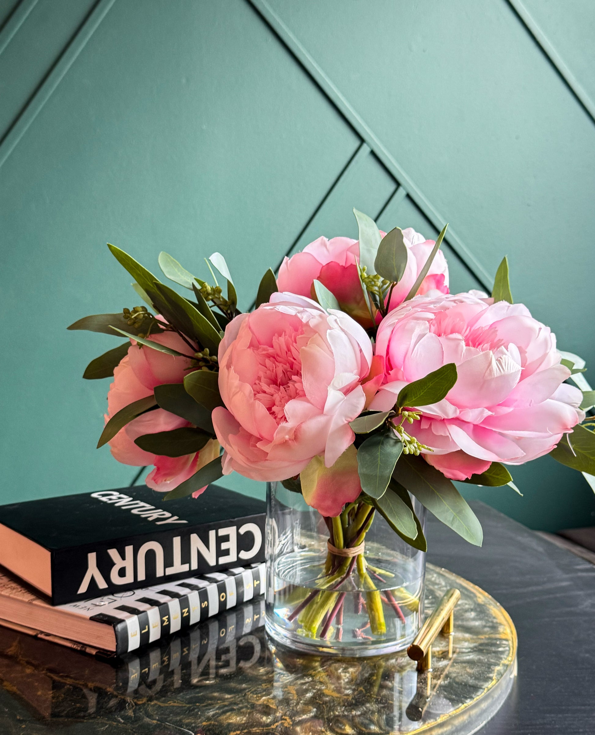 Elegant artificial peony arrangement with realistic blooms and greenery in a clear glass vase.