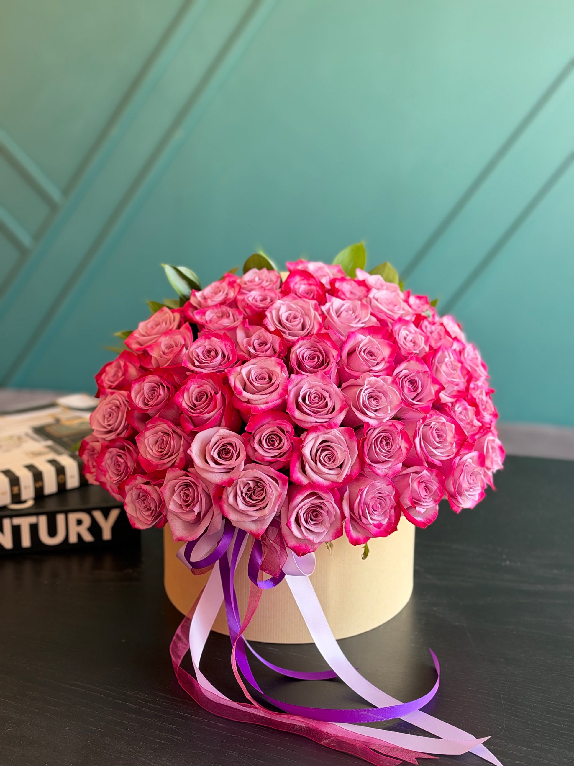Elegant deep purple rose arrangement in a round box in Miami Beach