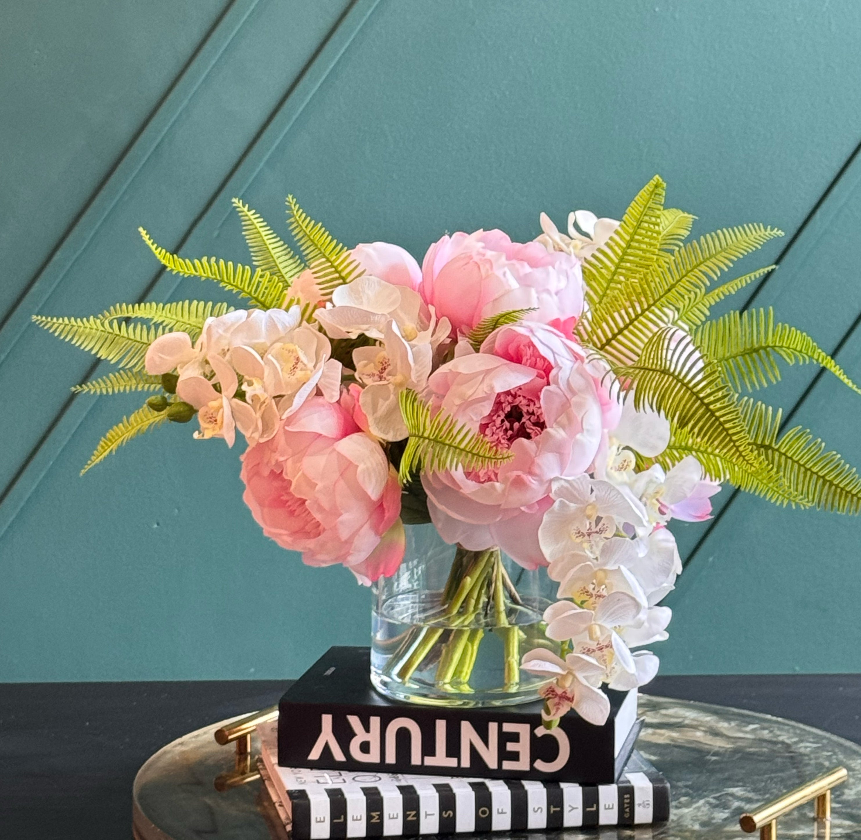 Elegant faux peony and orchid floral arrangement in a glass vase for luxury home and office décor.