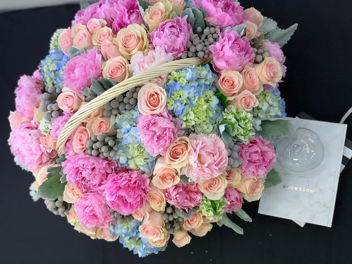 Elegant flower basket with pink peonies roses and hydrangeas