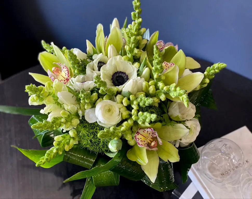 Elegant ivory and green floral arrangement by Luxury Flowers Miami