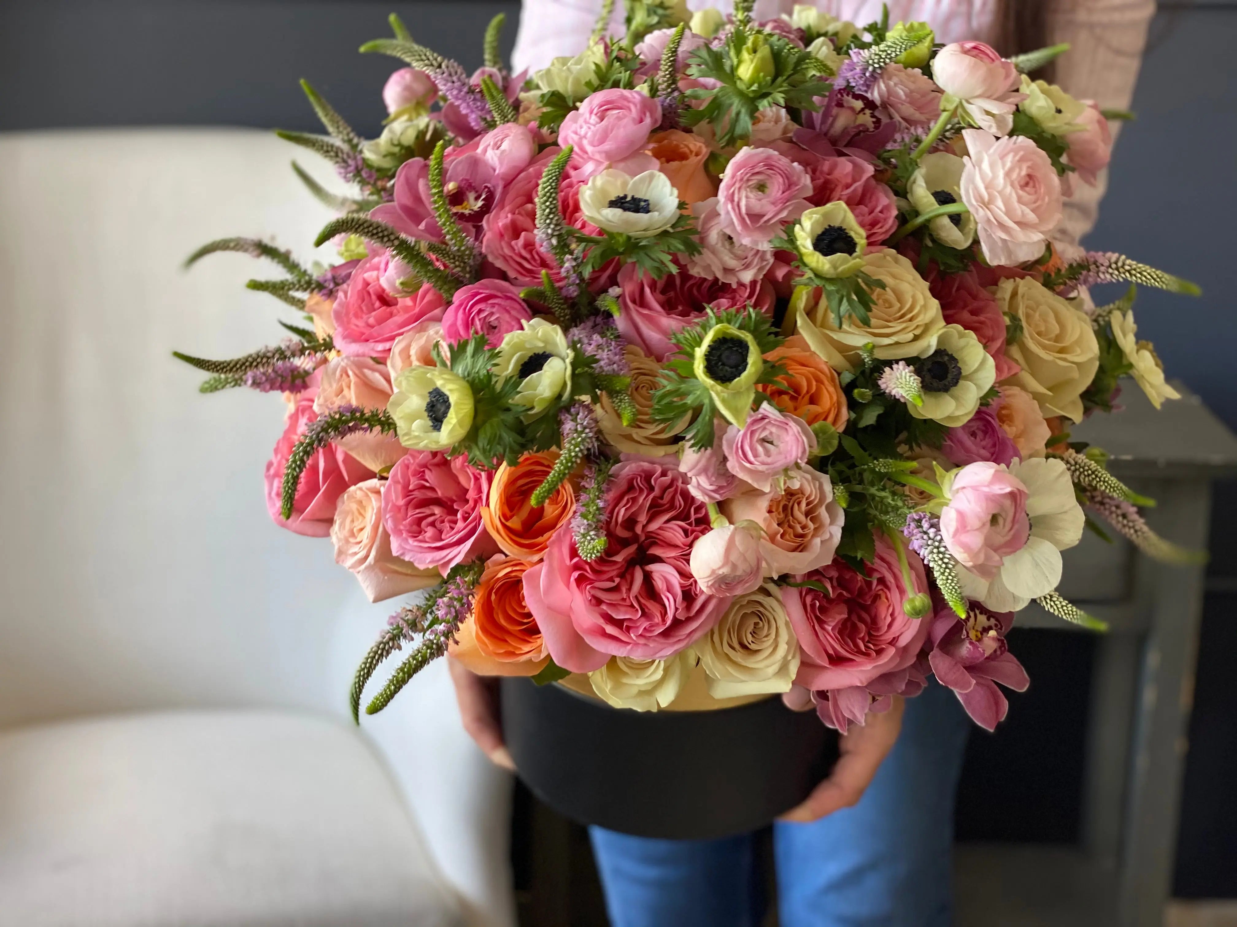 Elegant mixed flower box with garden roses and ranunculus