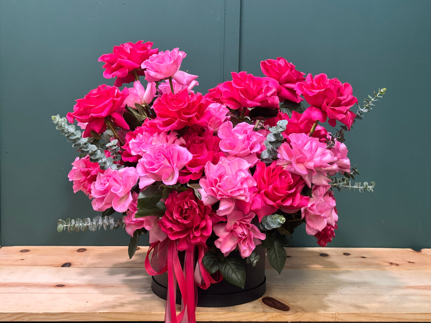 Elegant pink and fuchsia French roses in a modern black floral box