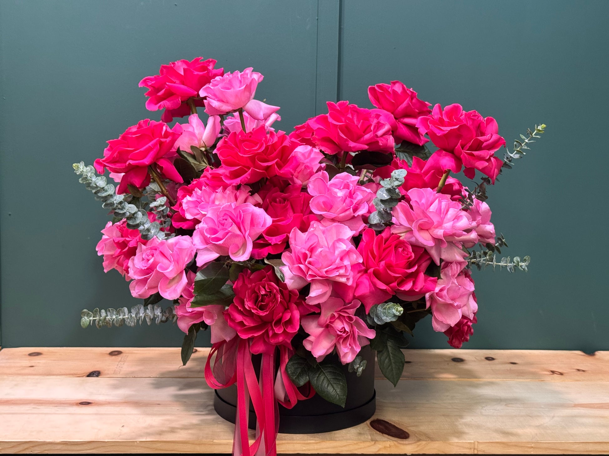 Elegant pink and fuchsia French roses in a modern black floral box