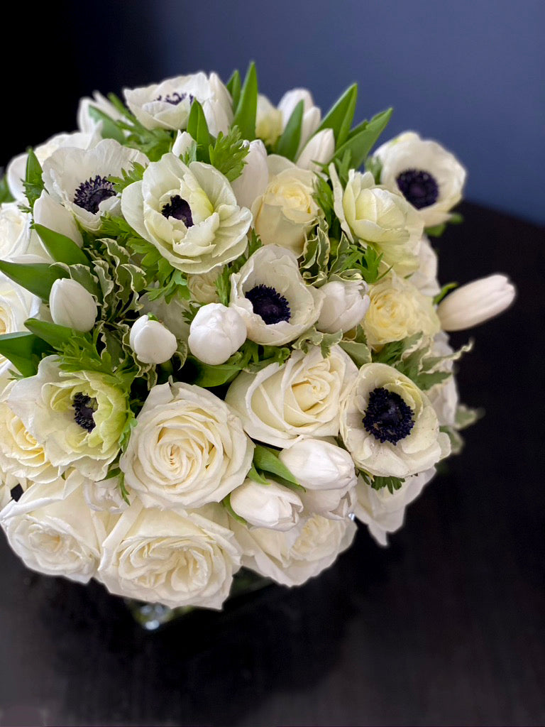 Elegant white floral arrangement with roses and tulips