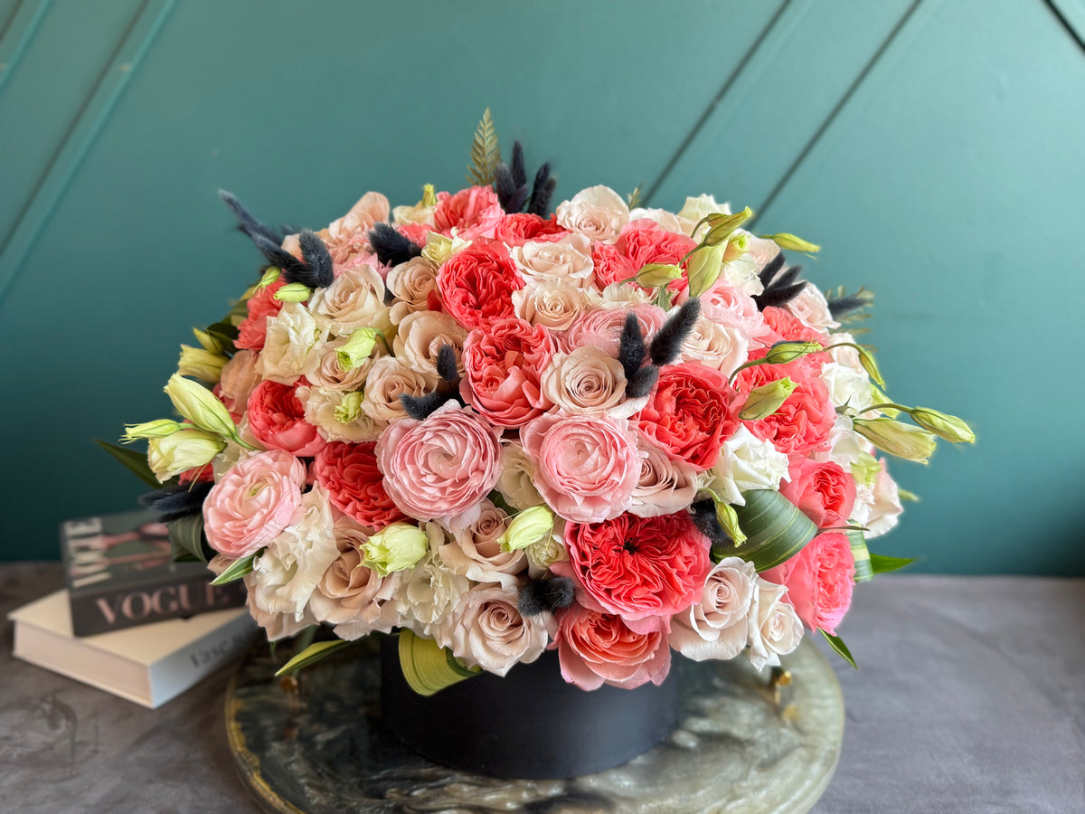 Front facing garden roses and ranunculus arrangement