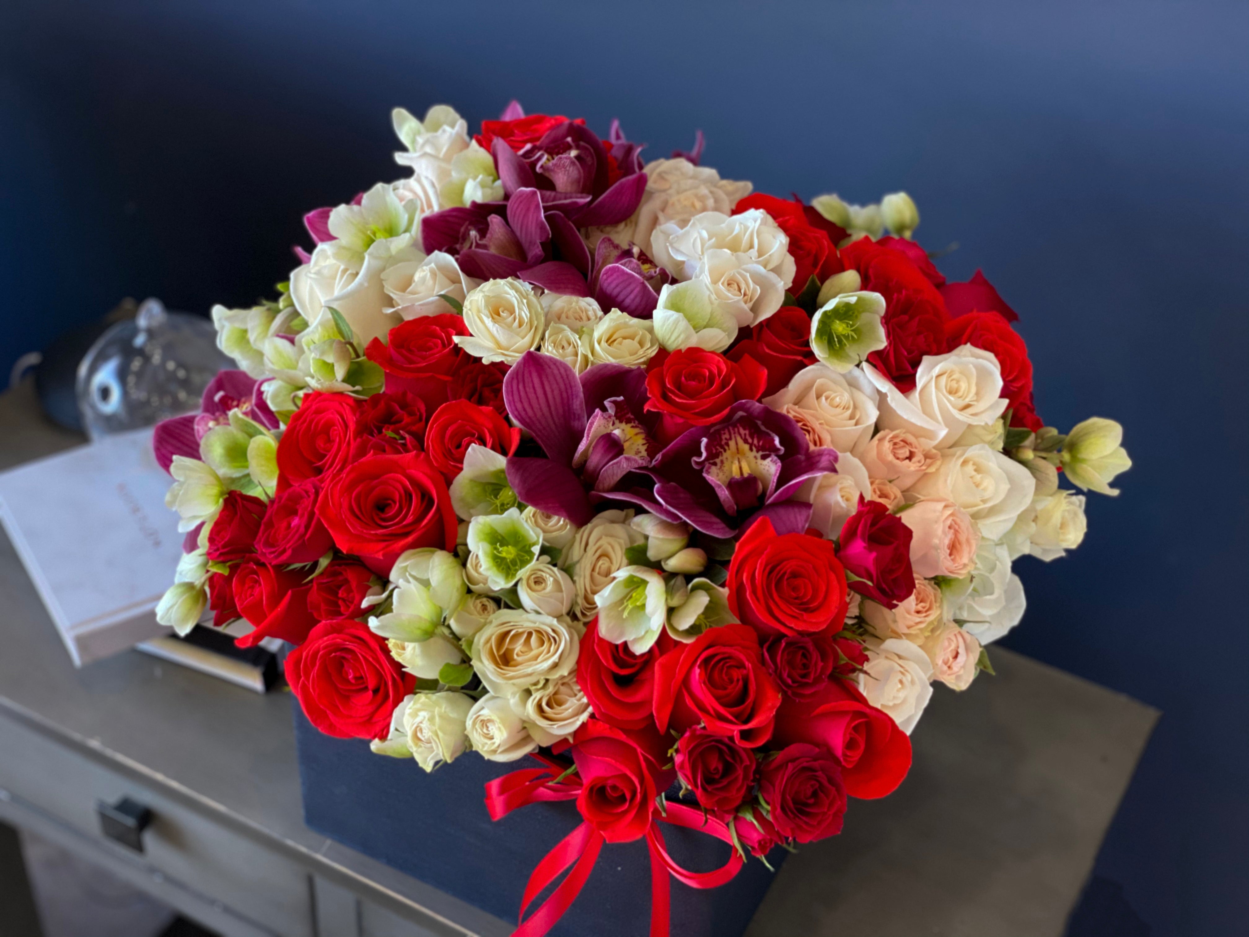Handcrafted rose and cymbidium orchid arrangement Miami Beach