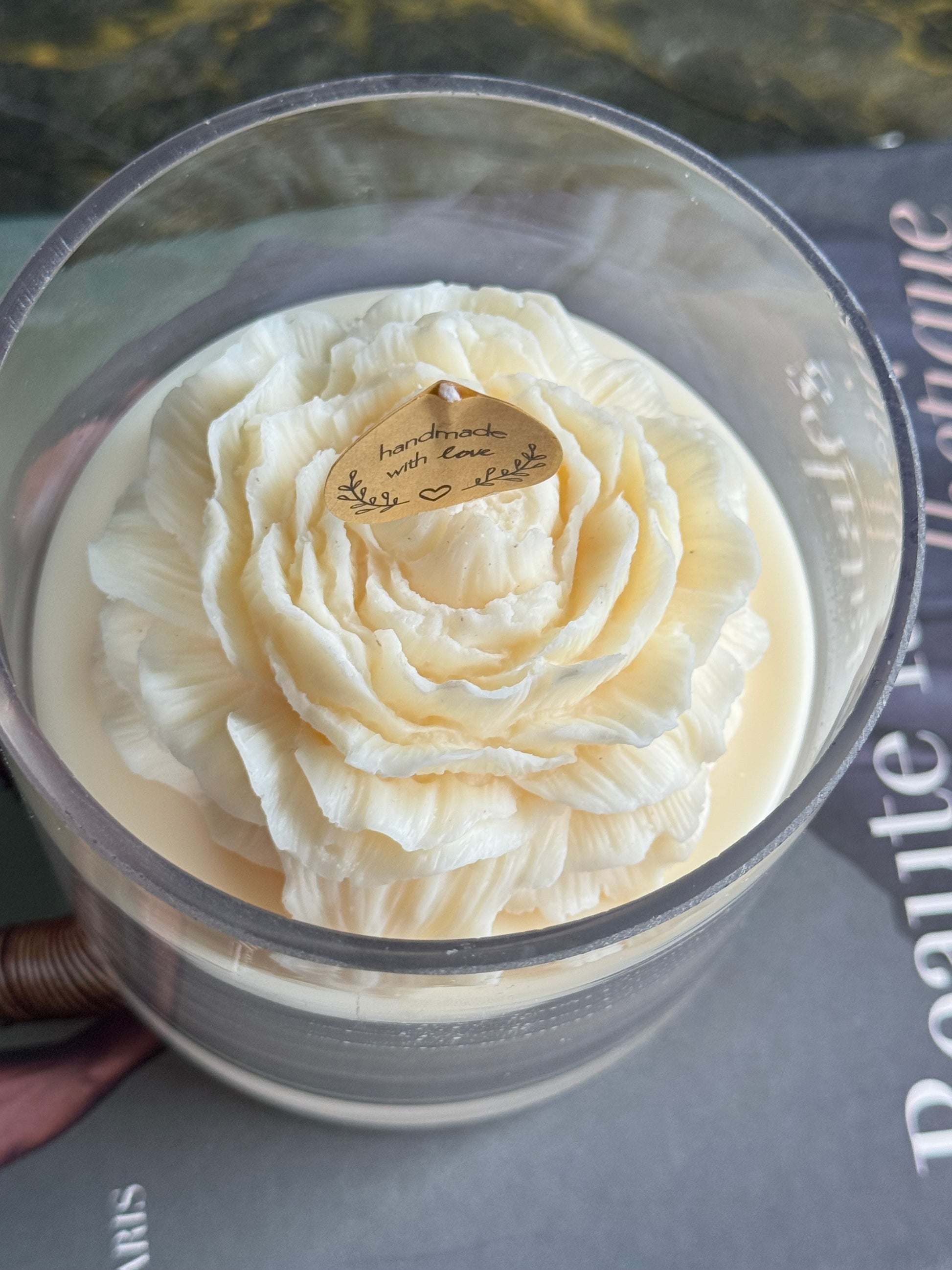 Handmade flower candle with detailed peony petals in glass vessel
