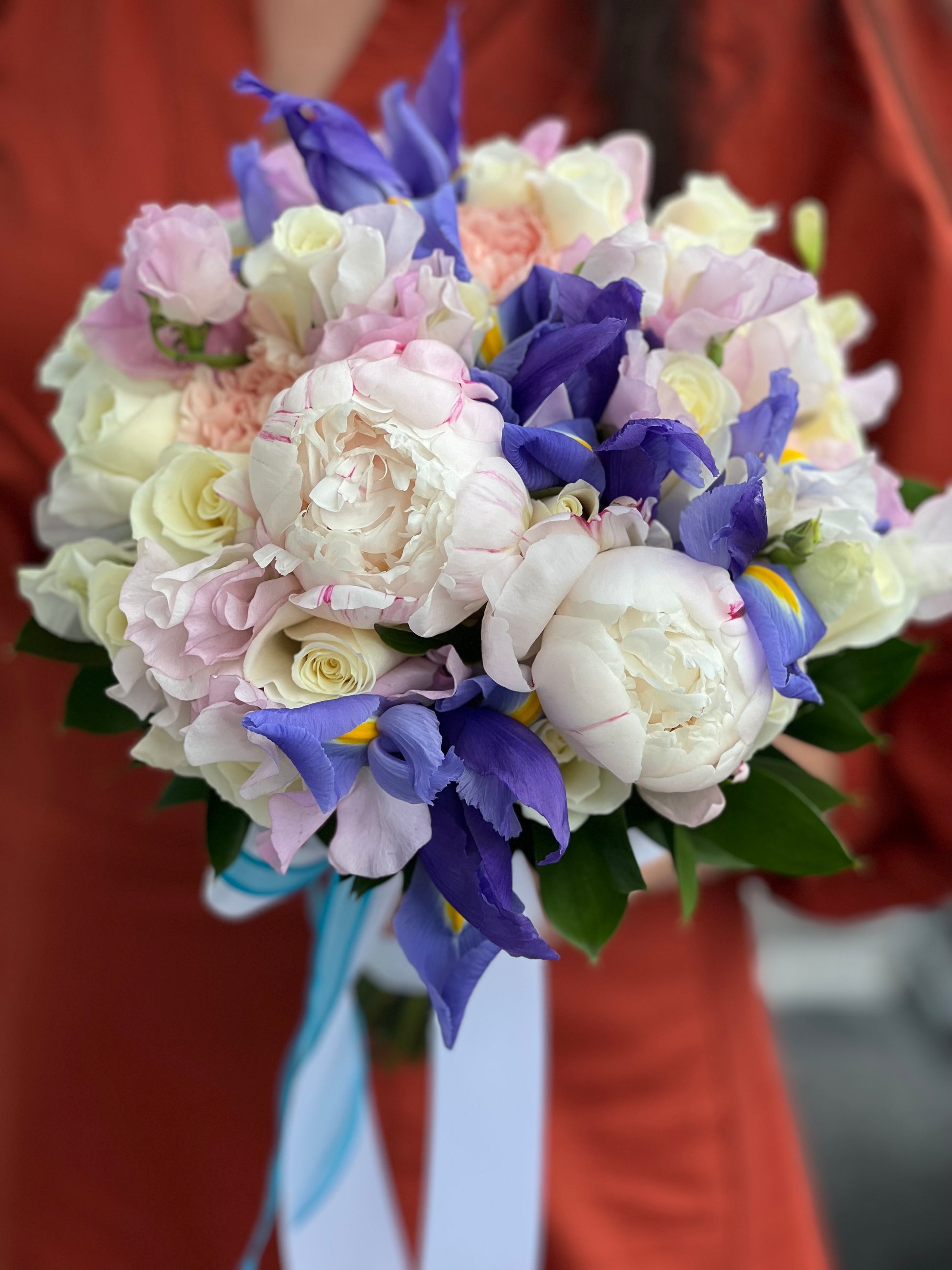 Luxury bridal bouquet with blue iris peonies roses and hydrangea